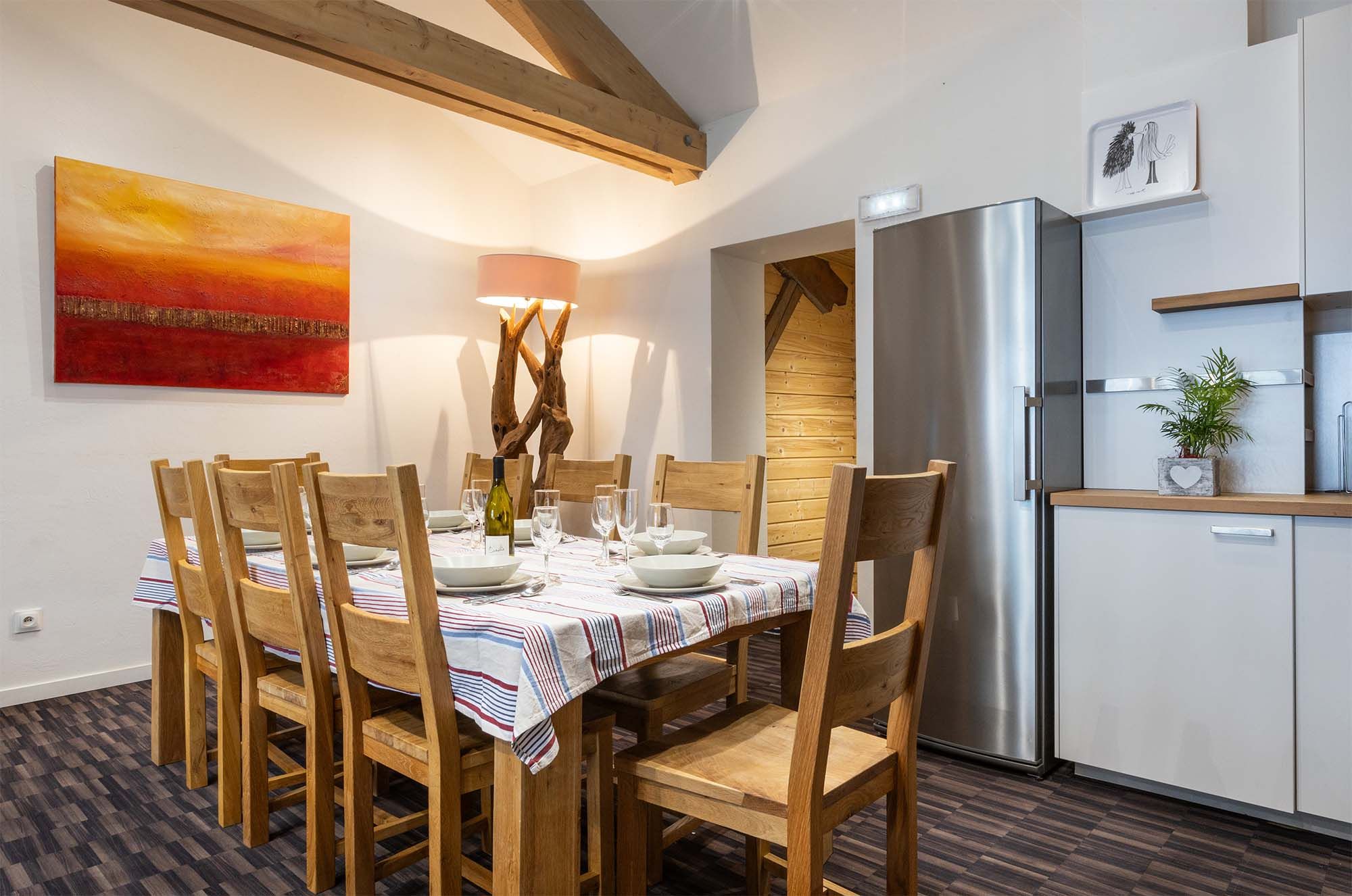 image The large wooden dining table comfortably seats your entire group, making it perfect for shared meals. T