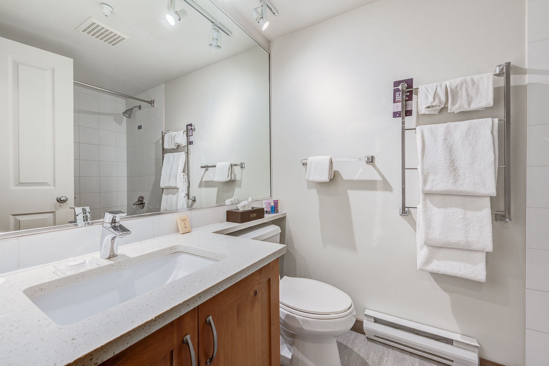 image Clean bathroom featuring a shower/tub combination and fresh towels.