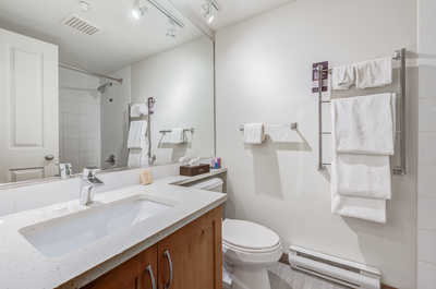 Clean bathroom featuring a shower/tub combination and fresh towels.