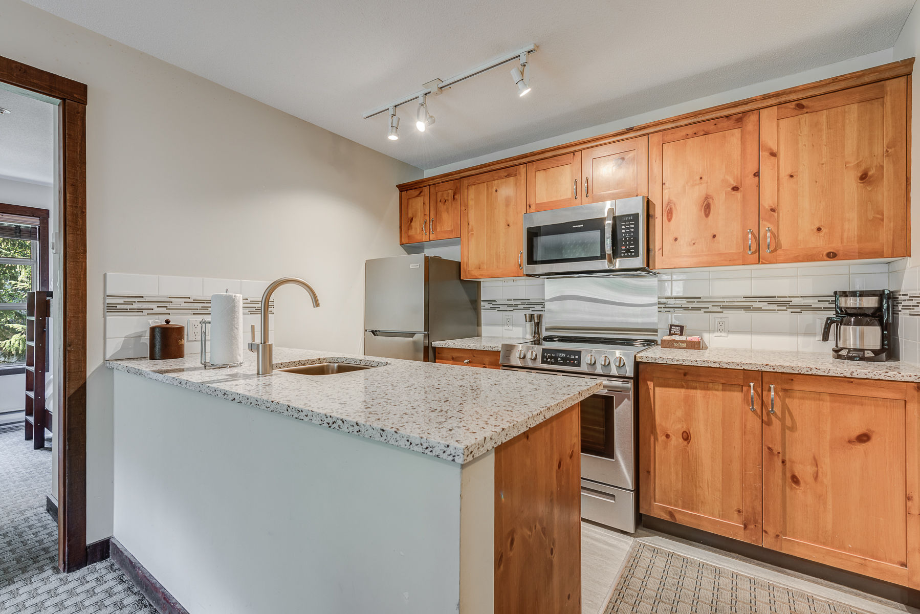 image Fully equipped kitchen with modern appliances and plenty of counter space.