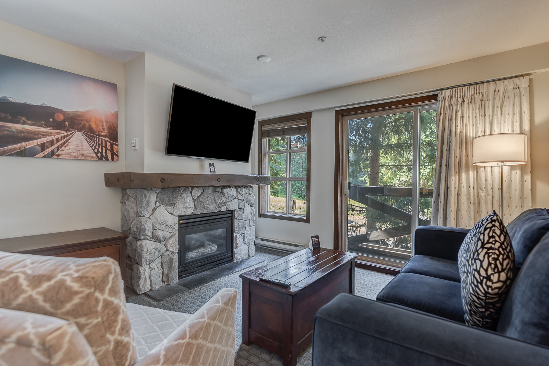 image Cozy living room with a stone fireplace and a TV, perfect for relaxing.