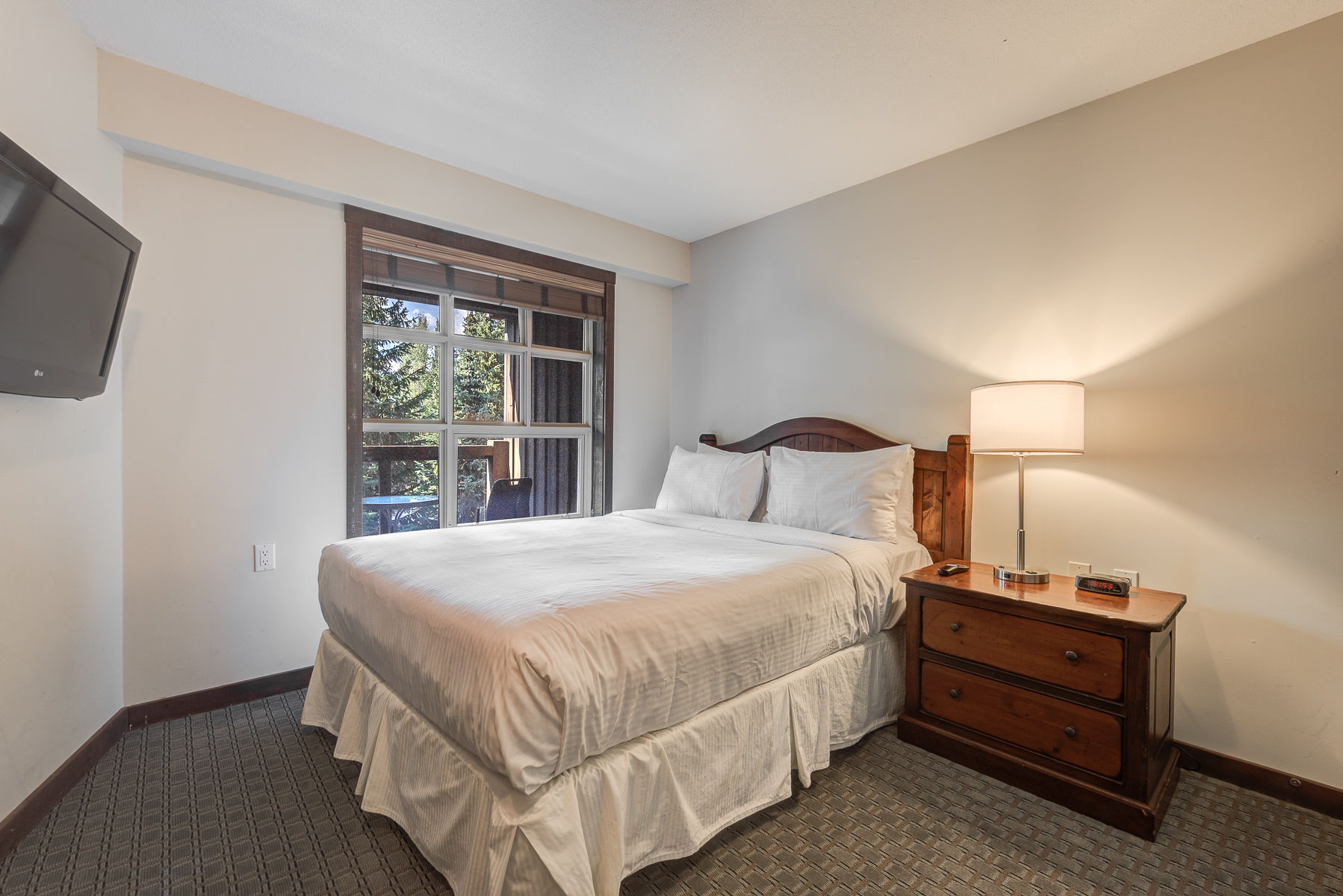 image Bright bedroom with a comfortable bed and soft lighting for relaxation.