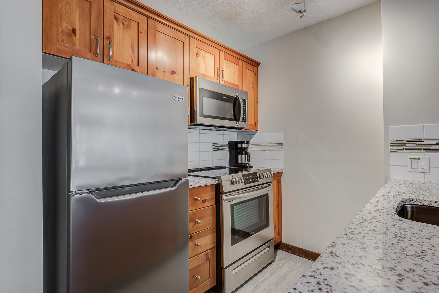 image Modern kitchen with stainless steel appliances and spacious counters.