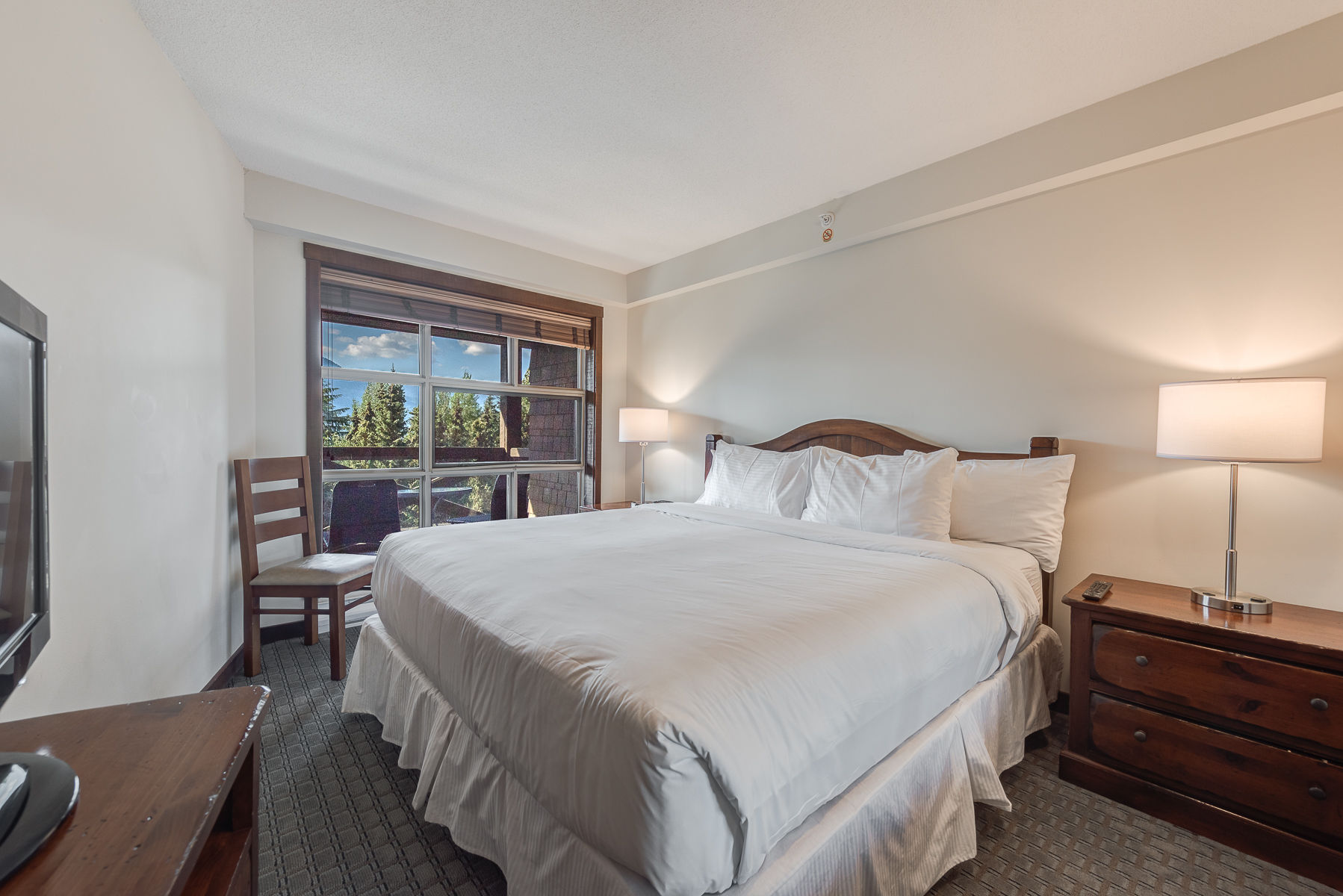 image Bright bedroom with a comfortable bed and plenty of natural light.