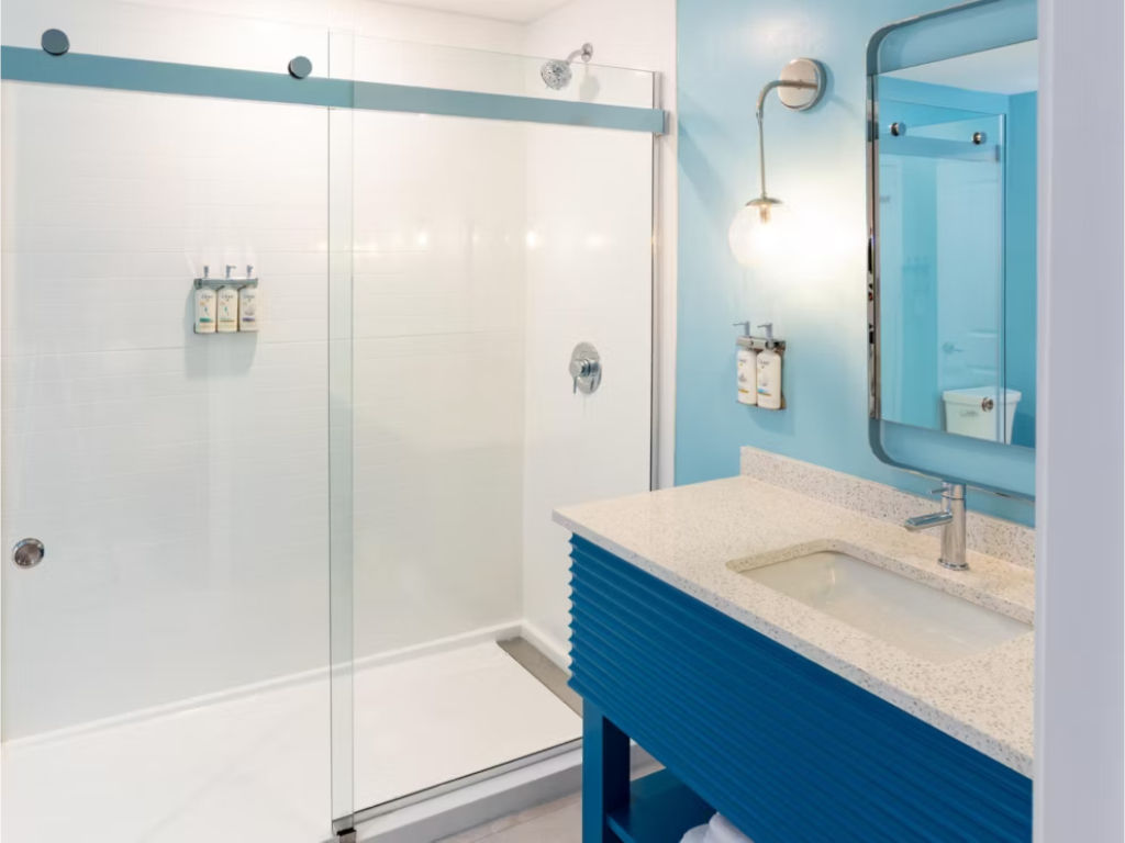 image Walk-in shower with a sleek glass enclosure and contemporary finishes for a refreshing experience.