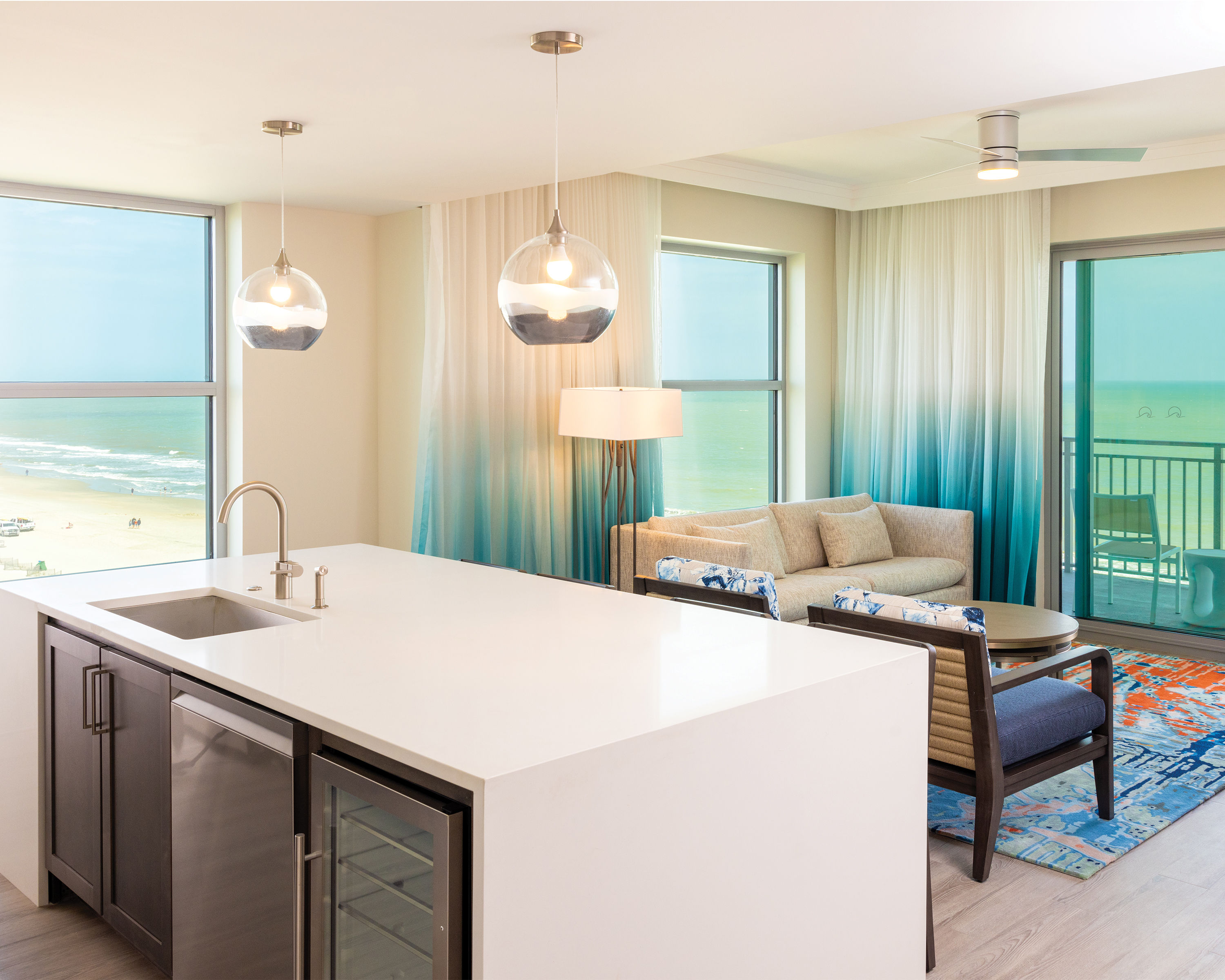image Bright and airy living area, featuring a modern kitchen and open layout.