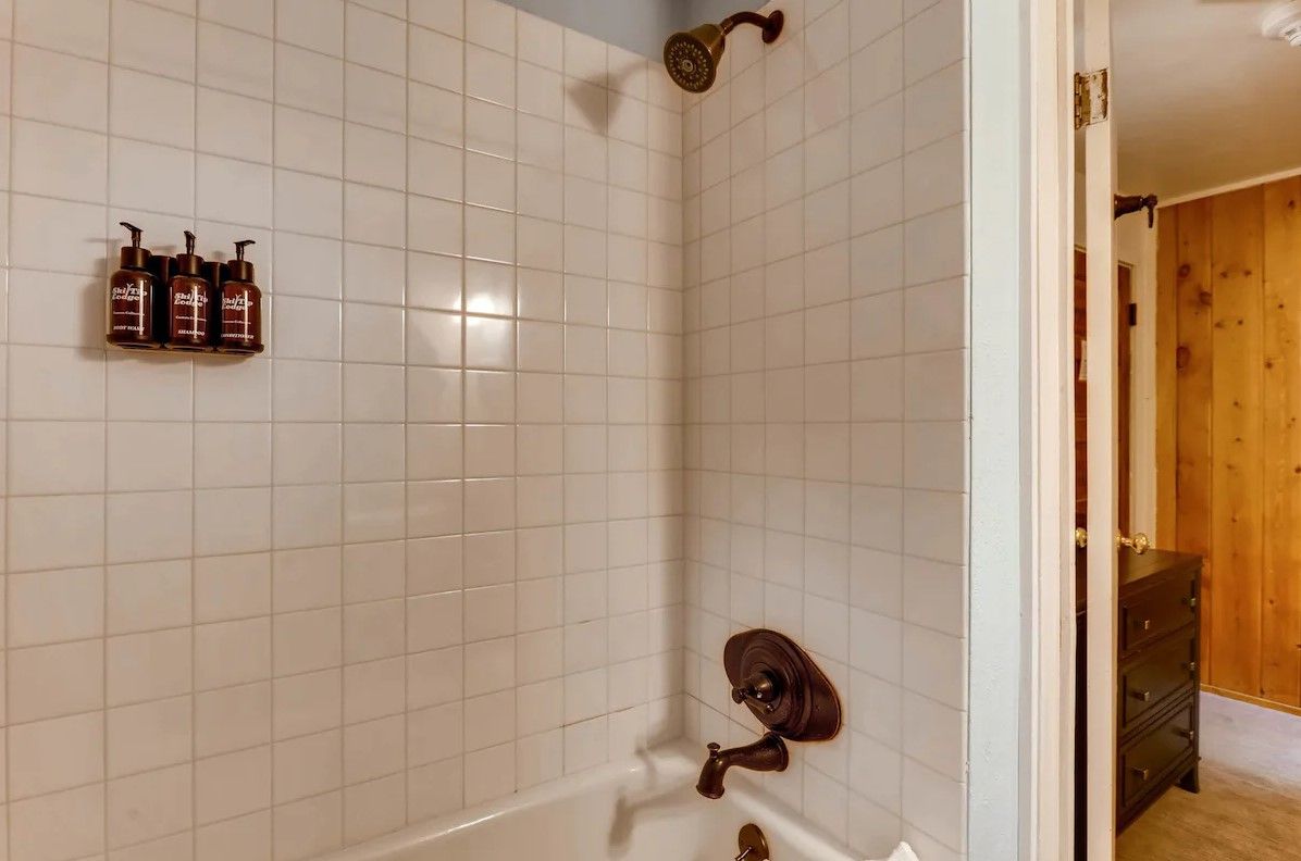 image Bright and simple bath area with clean tilework and modern fixtures, perfect for a refreshing start to the day.