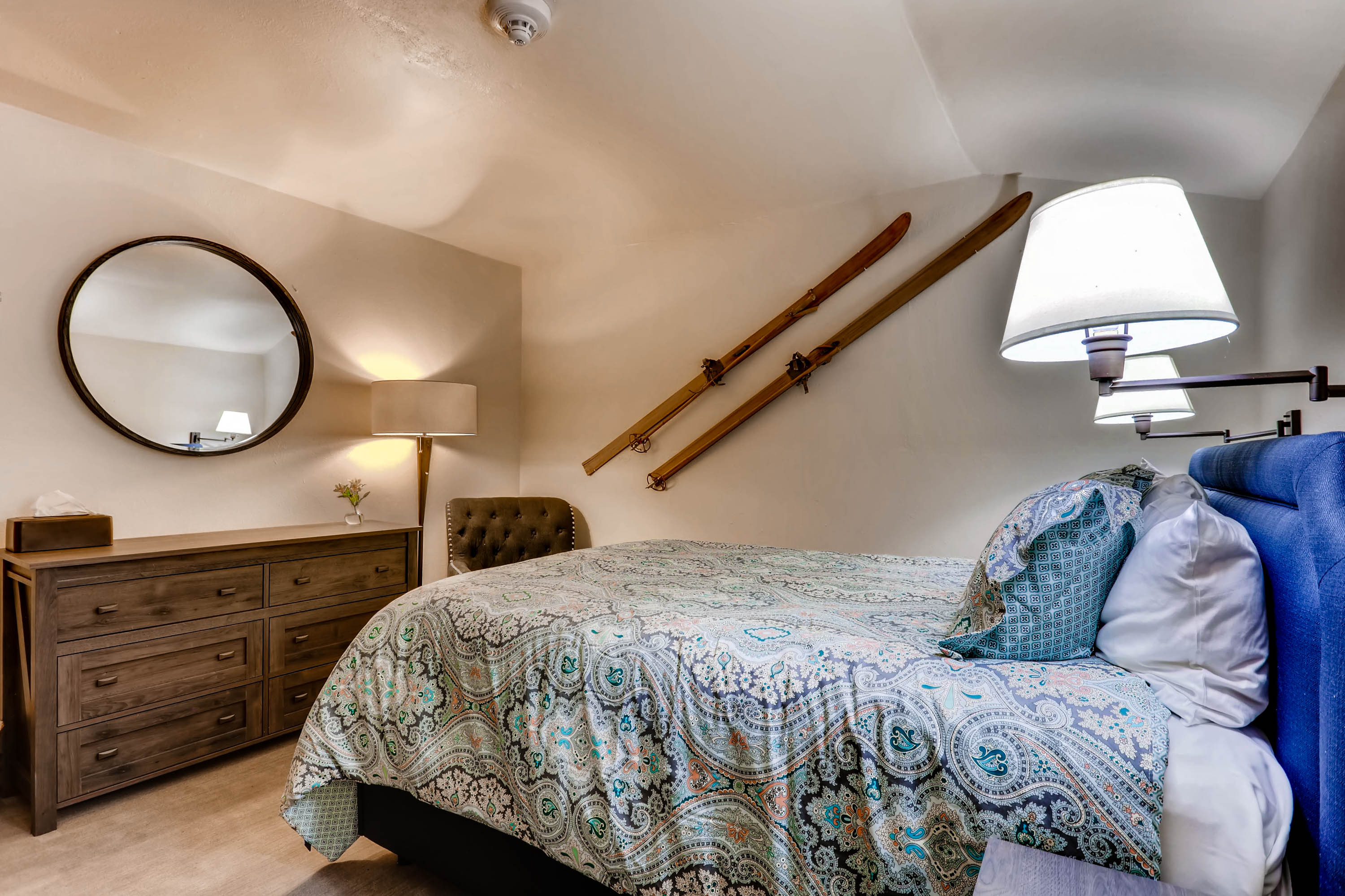 image Charming attic-style room with a cozy bed, rustic touches, and a soothing ambiance for restful nights.