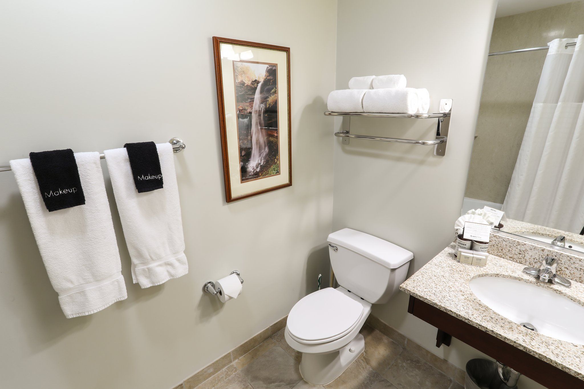 image Clean and bright bathroom with modern fixtures and plenty of towels.