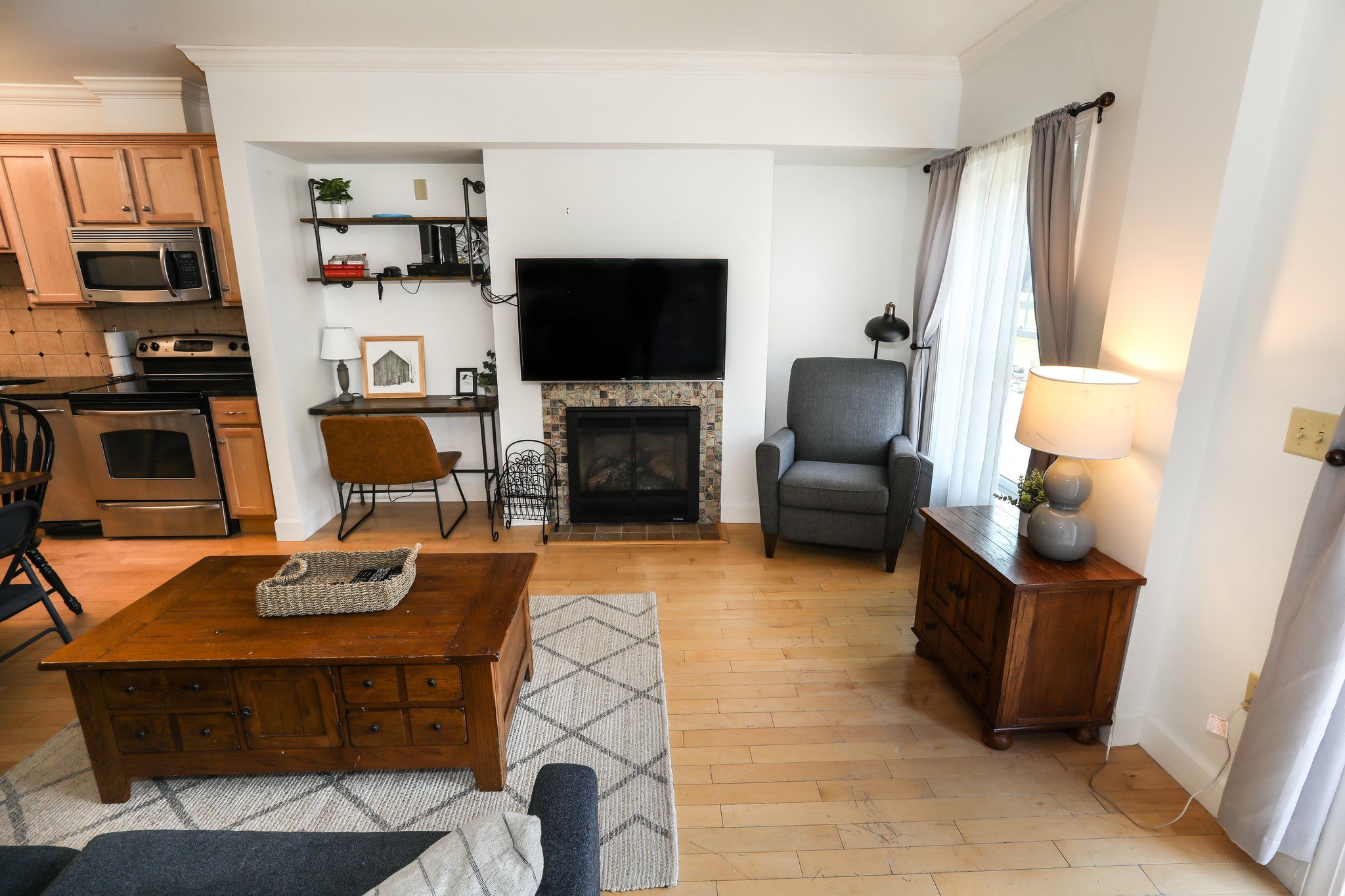 image Bright and airy living space with a fireplace and an open layout, creating a warm and welcoming atmosphere.