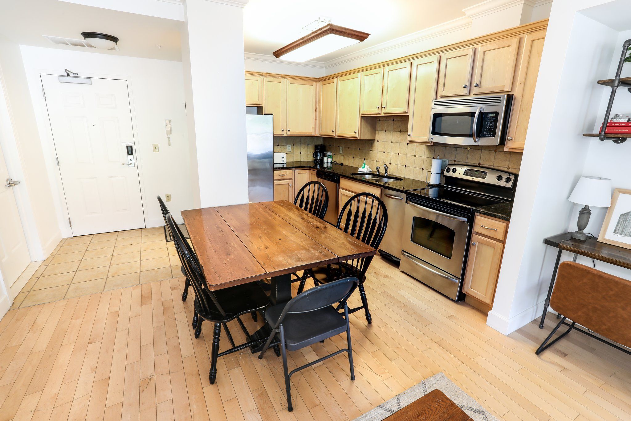 image Well-appointed kitchen with modern appliances and a dining area, perfect for enjoying meals together.