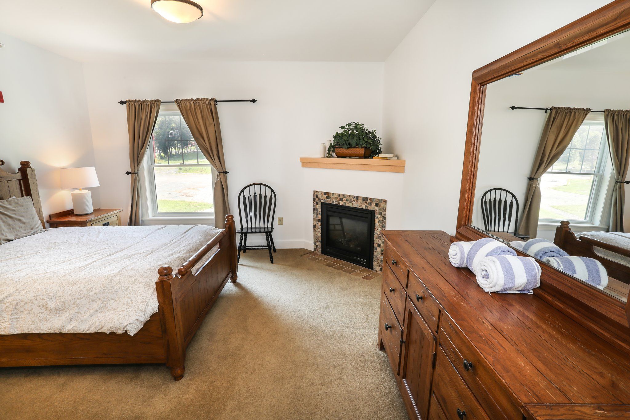 image Spacious bedroom with elegant furnishings, soft lighting, and a cozy fireplace for added comfort.