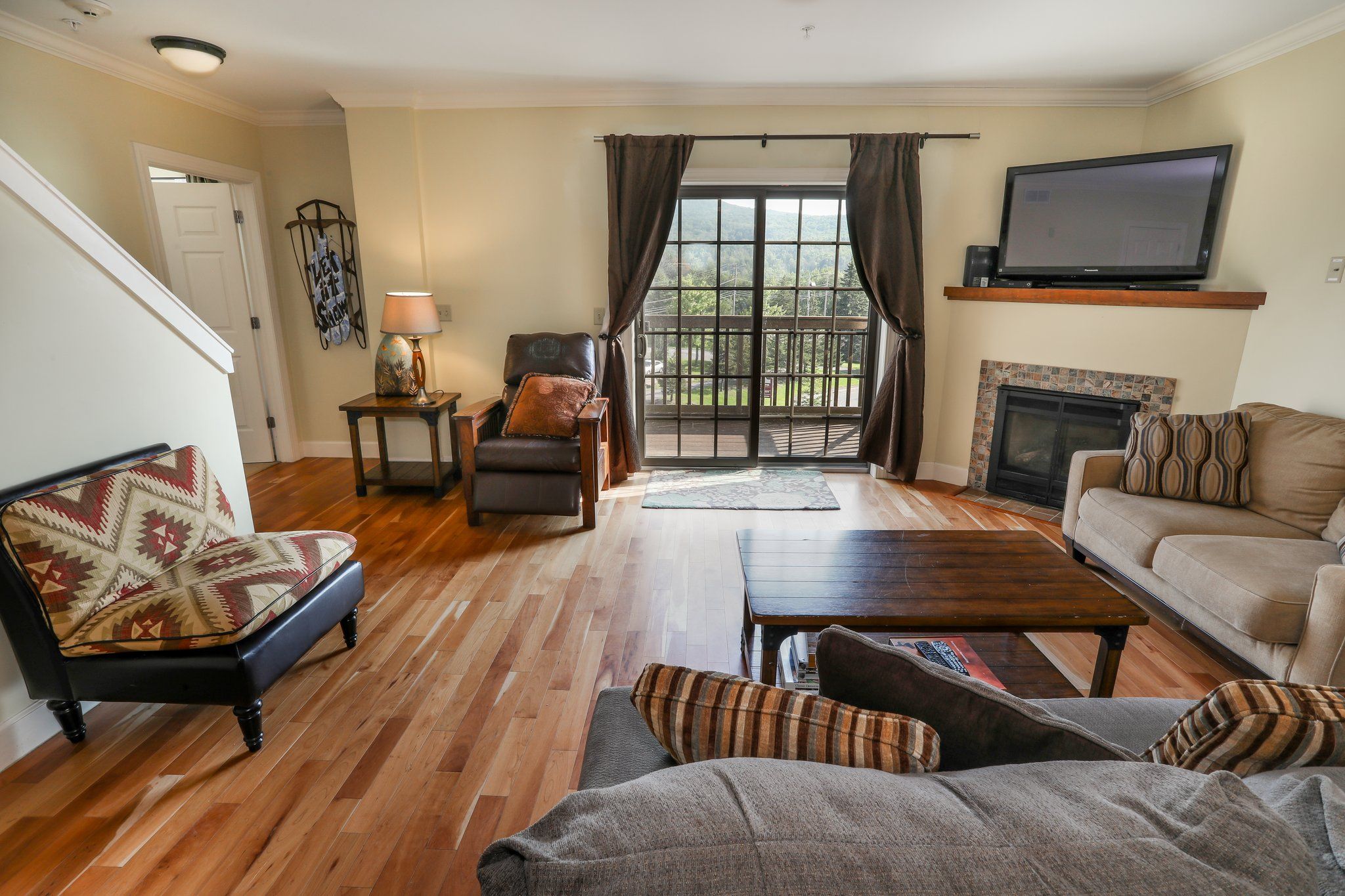 image Spacious living area with comfortable seating and a fireplace, perfect for relaxing after a day of exploring.
