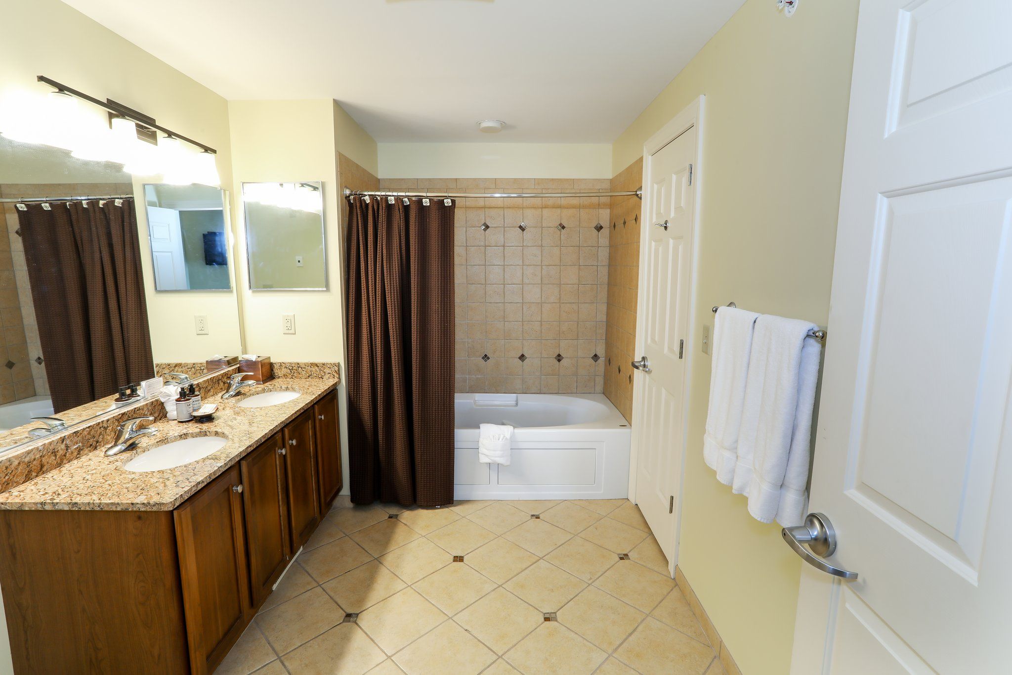 image Bright bathroom with a combination shower and tub, offering convenience and comfort during your stay.