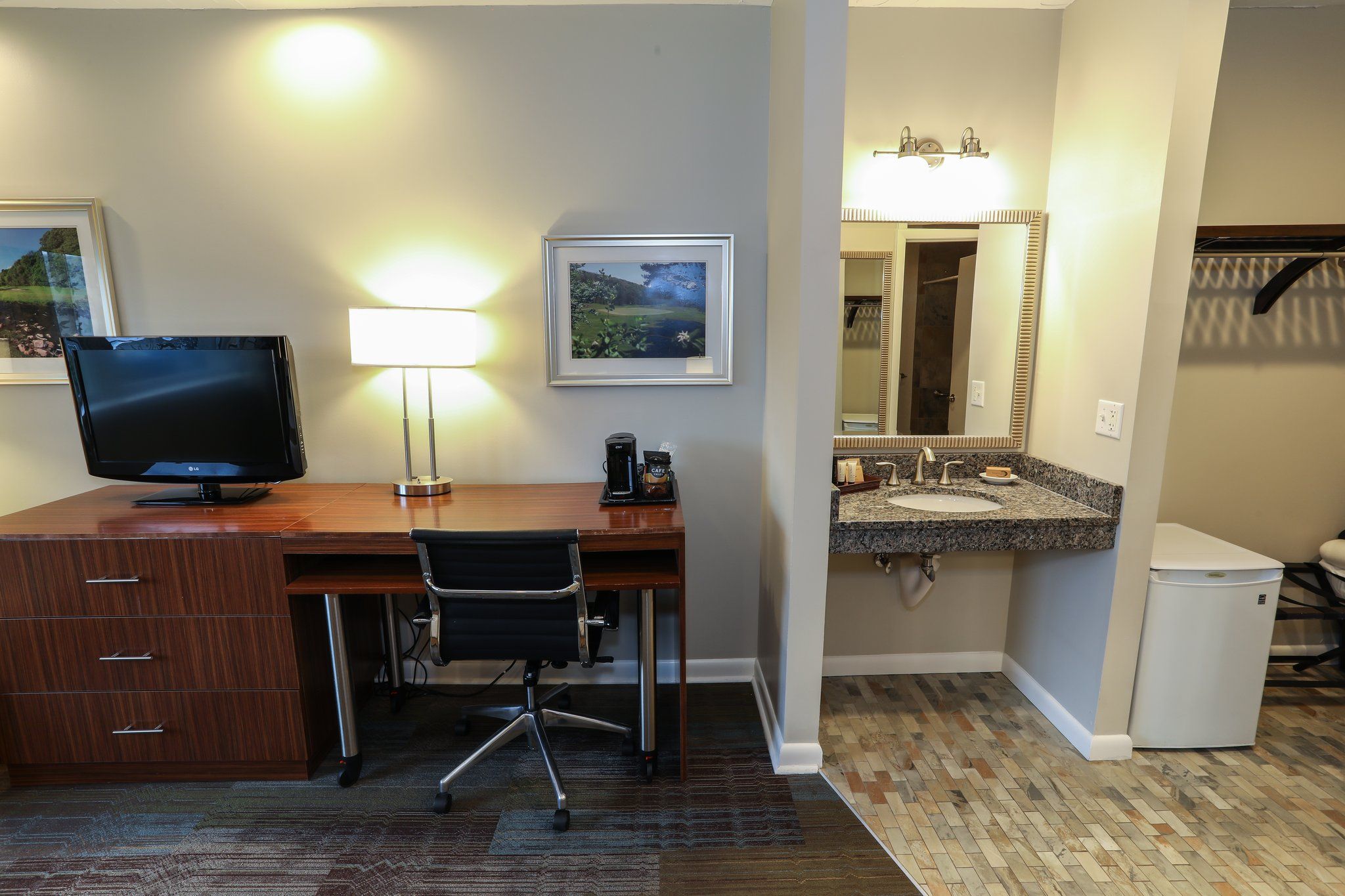 image Spacious work area with a desk and modern amenities, perfect for business travelers.