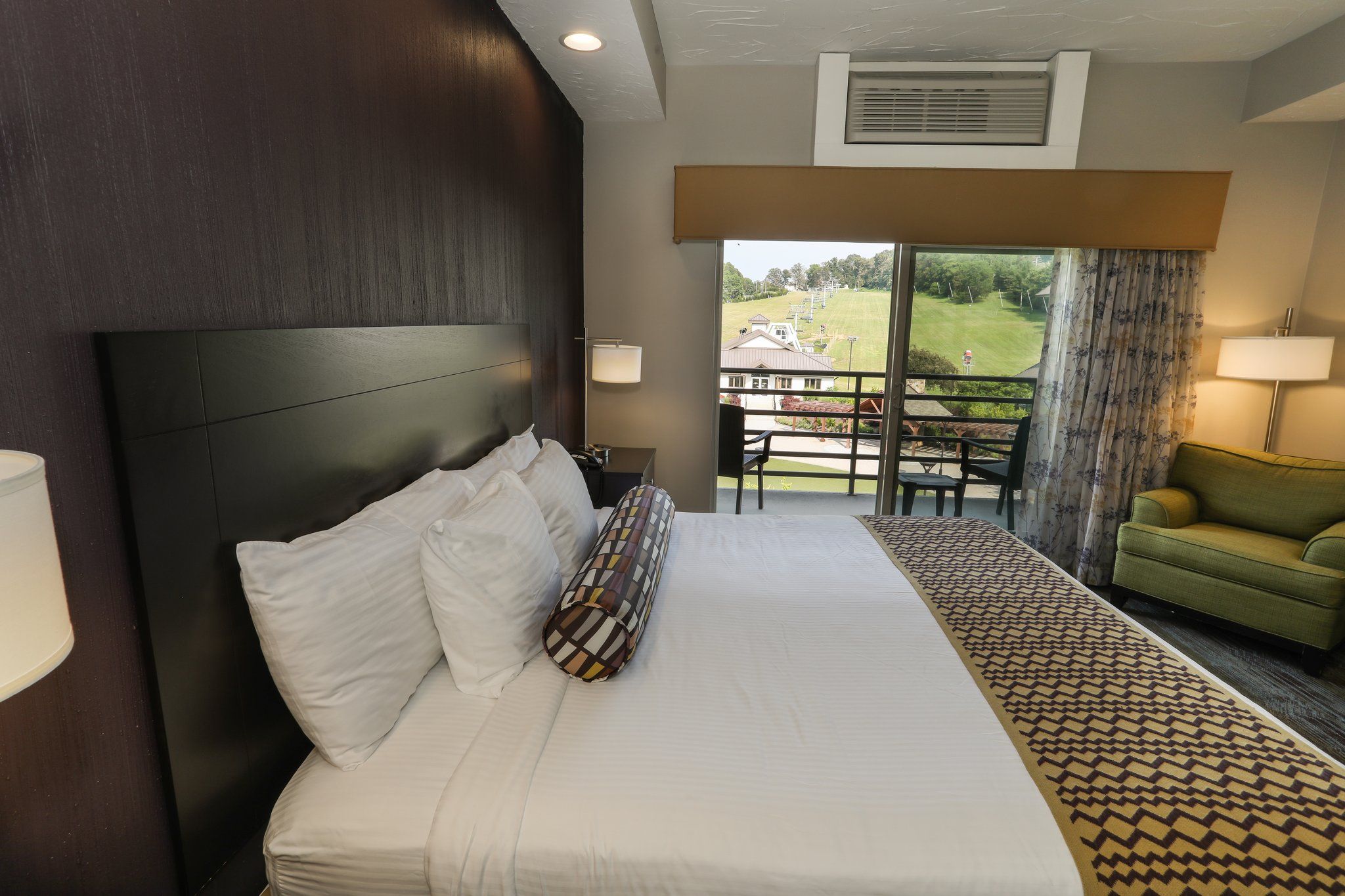 image Cozy guest room with a plush bed and a private balcony, perfect for relaxation.