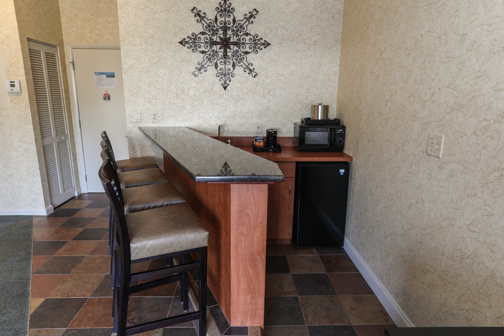 image Compact kitchenette with a breakfast bar, perfect for preparing snacks and light meals.