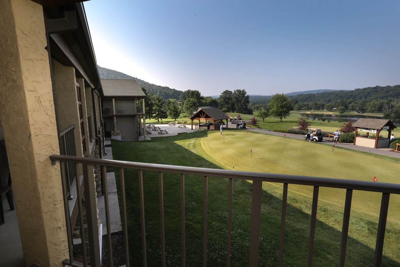image Enjoy peaceful balcony views overlooking the rolling greens and scenic mountain backdrop.