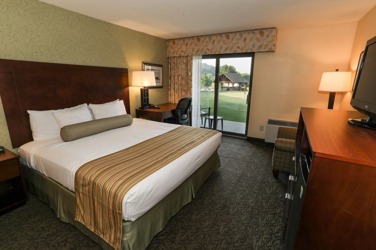 image Cozy room with a comfortable bed, TV, and private balcony access for a relaxing stay.