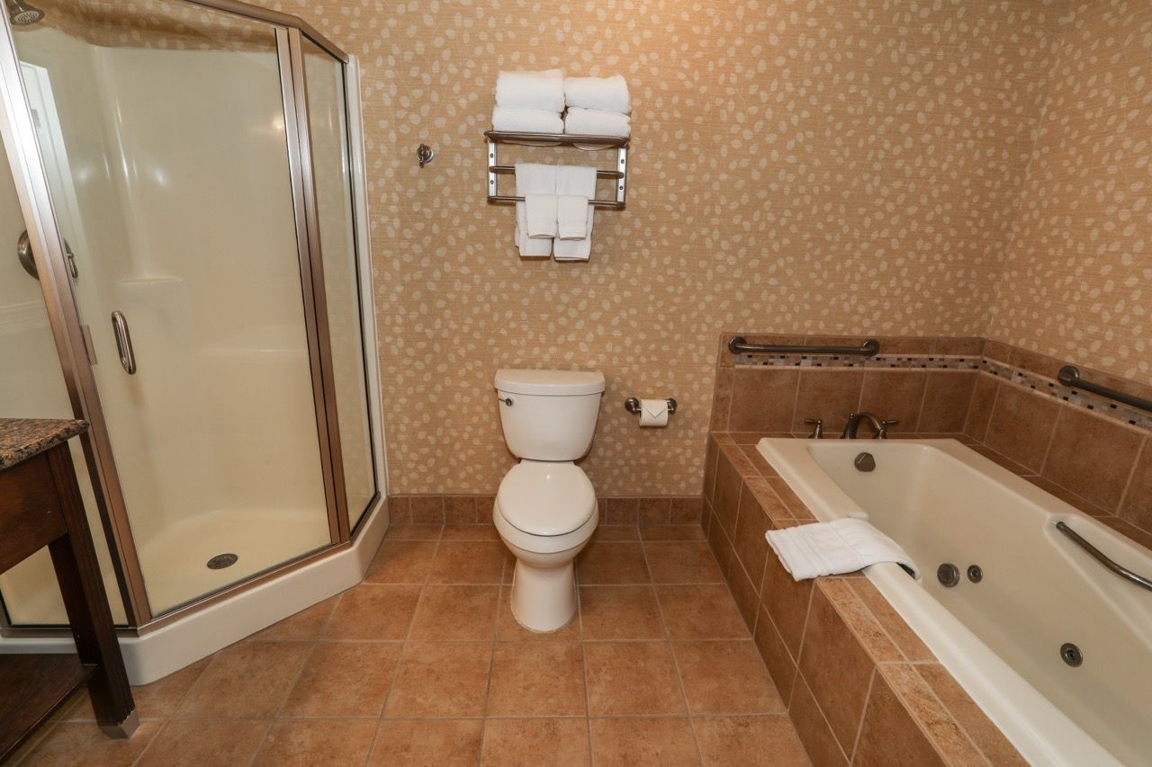 image Elegant bathroom with a spacious walk-in shower and classic vanity for a refreshing experience.