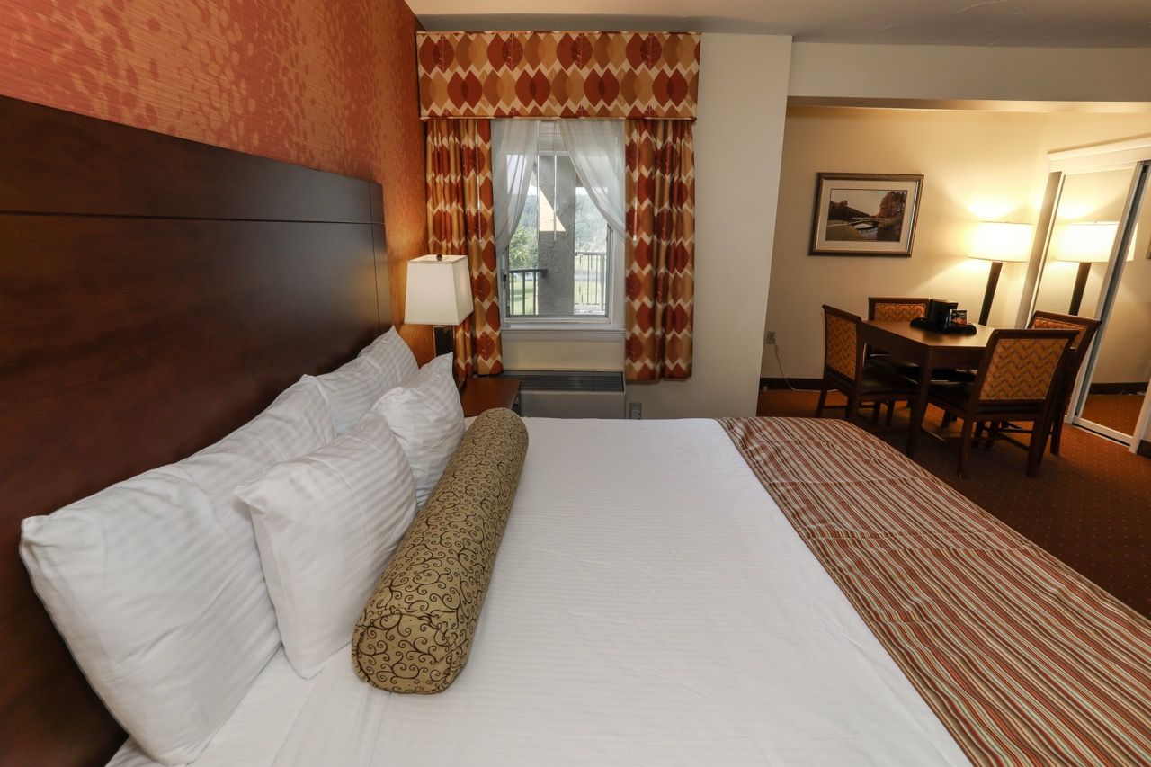 image Comfortable guest room with a plush bed and access to a private balcony with scenic views.
