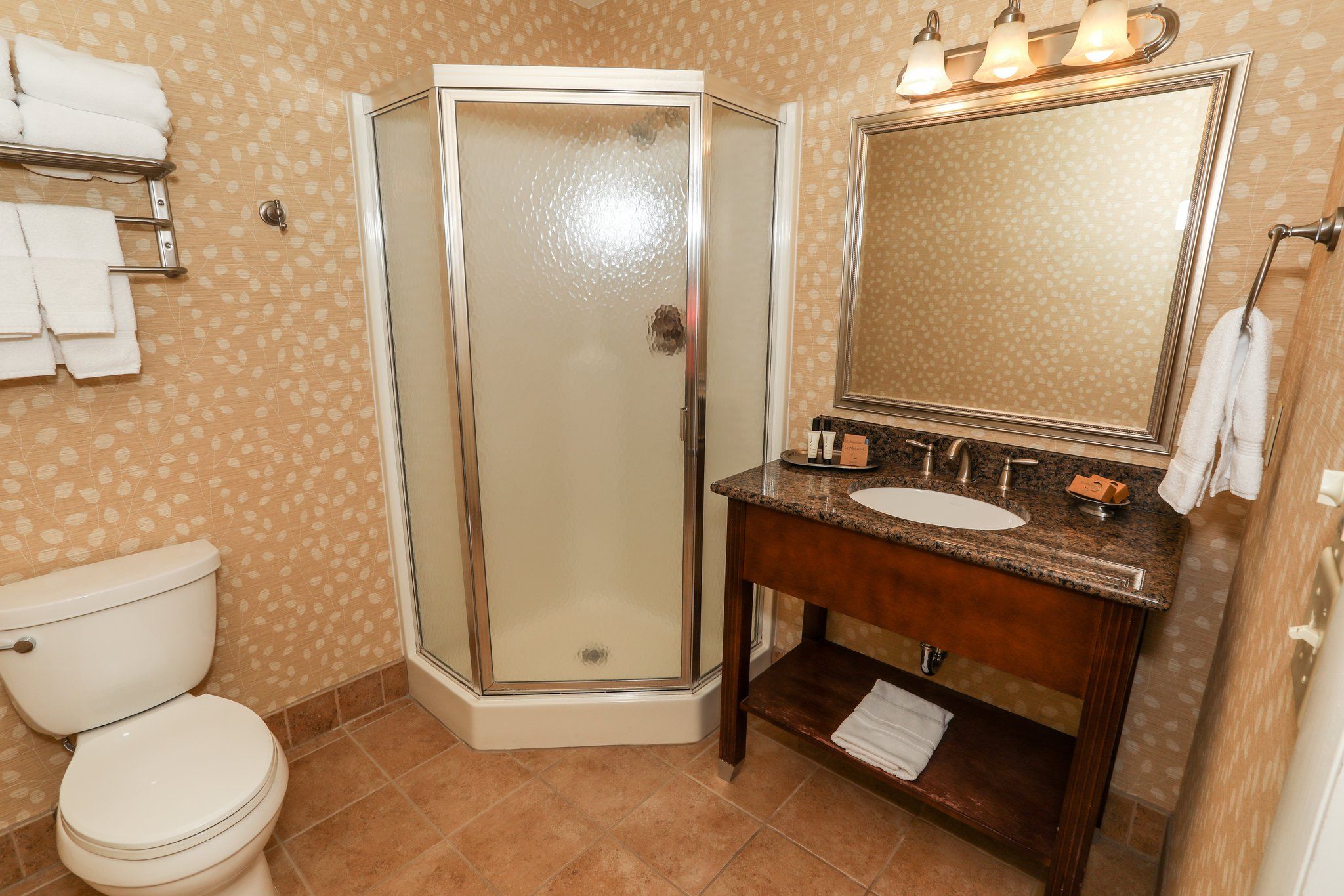 image Elegant bathroom with a walk-in shower and classic vanity, providing modern amenities.