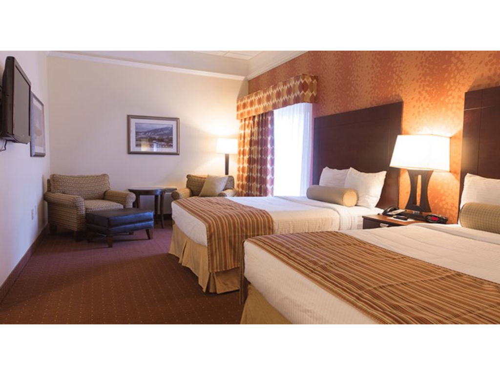 image Cozy room with comfortable bedding and a sitting area, perfect for unwinding after a busy day.