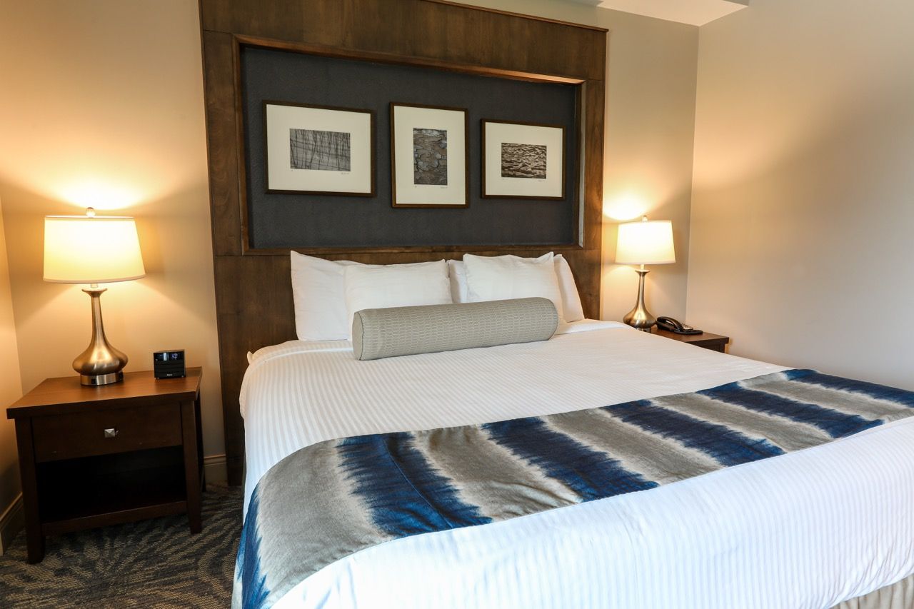 image Elegant room featuring a plush bed, stylish décor, and bedside lighting for a cozy ambiance.