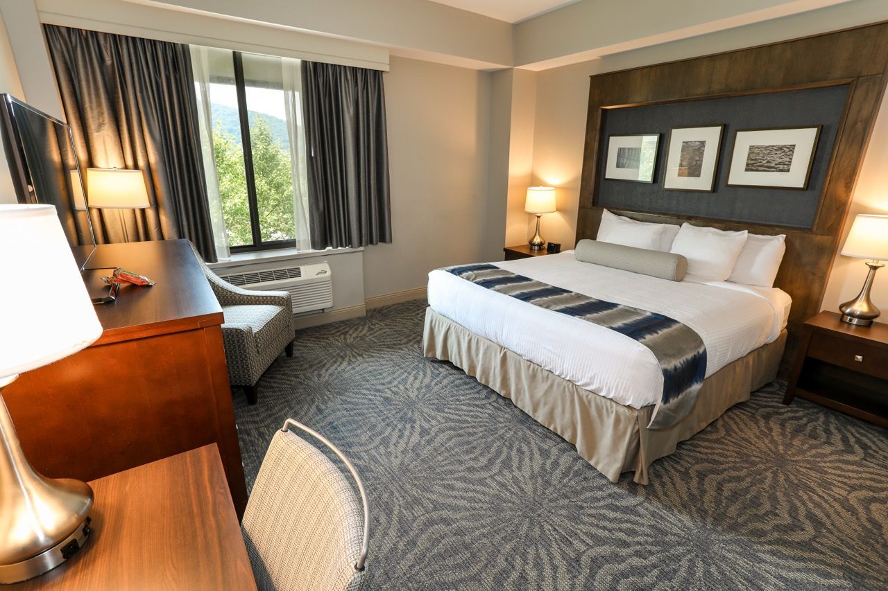 image Elegant and inviting guest room with plush bedding and warm décor.