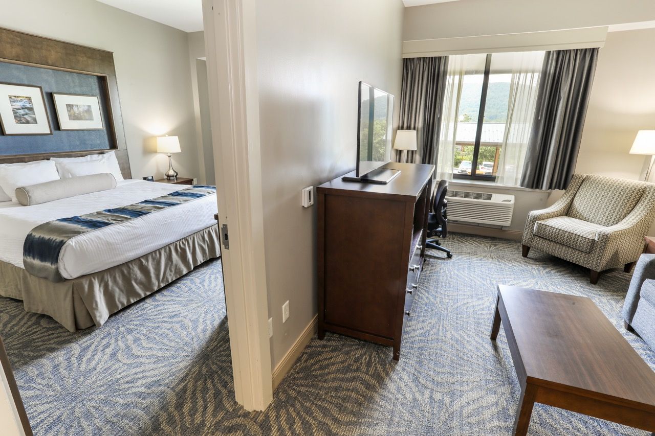 image Spacious guest room with a comfortable bed and a cozy seating area for relaxation.