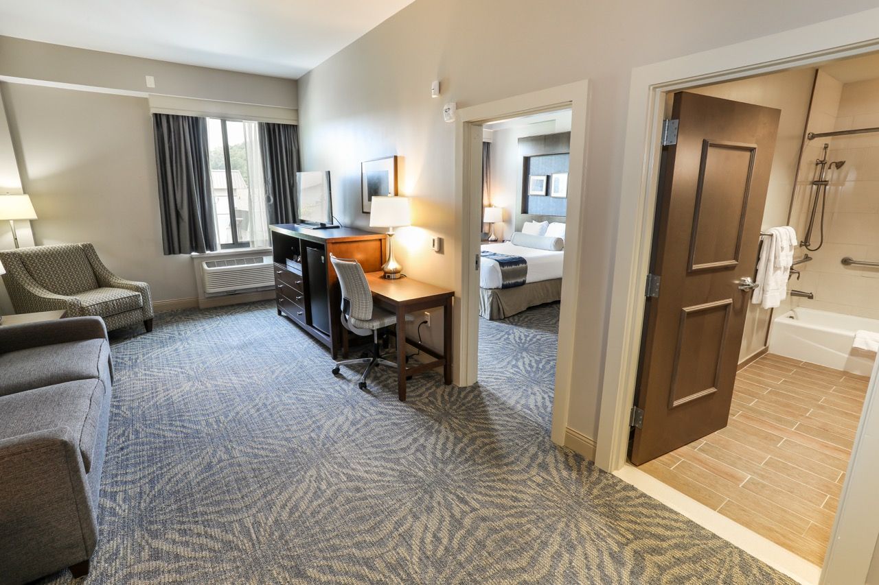 image Well-appointed suite offering a work desk and ample seating, ideal for both work and leisure.