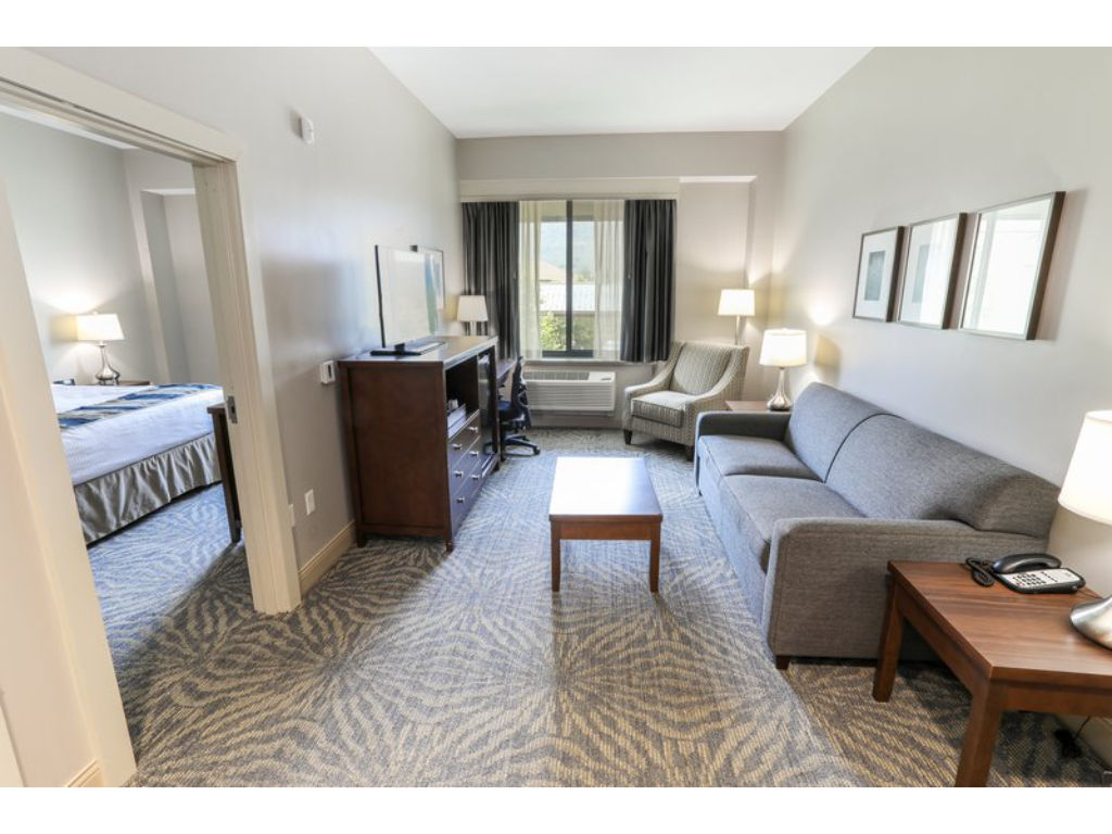 image Comfortable suite with a separate living area, perfect for relaxing after a long day.