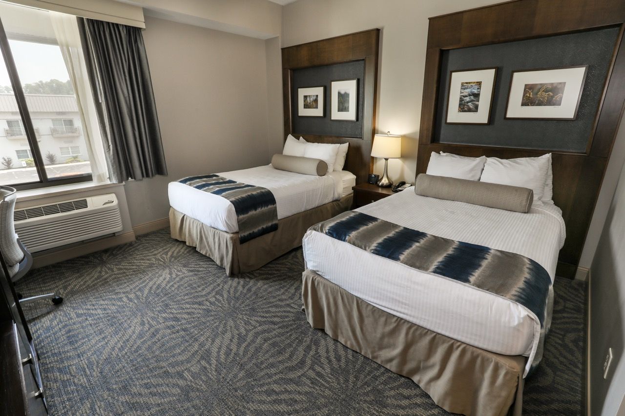 image Bright and airy room with two plush beds and plenty of natural light.