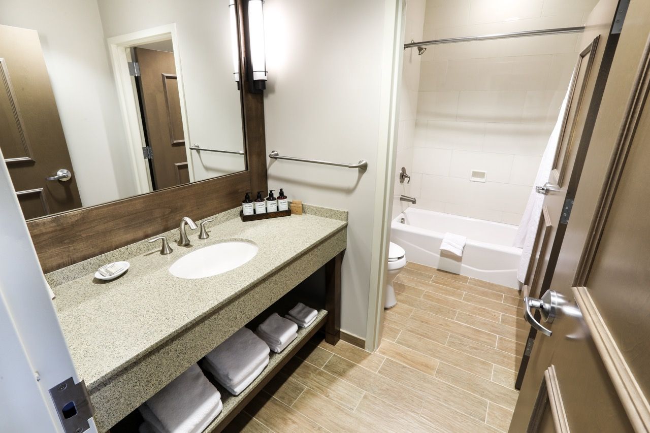 image Stylish bathroom with a large vanity and walk-in shower, offering convenience and comfort.