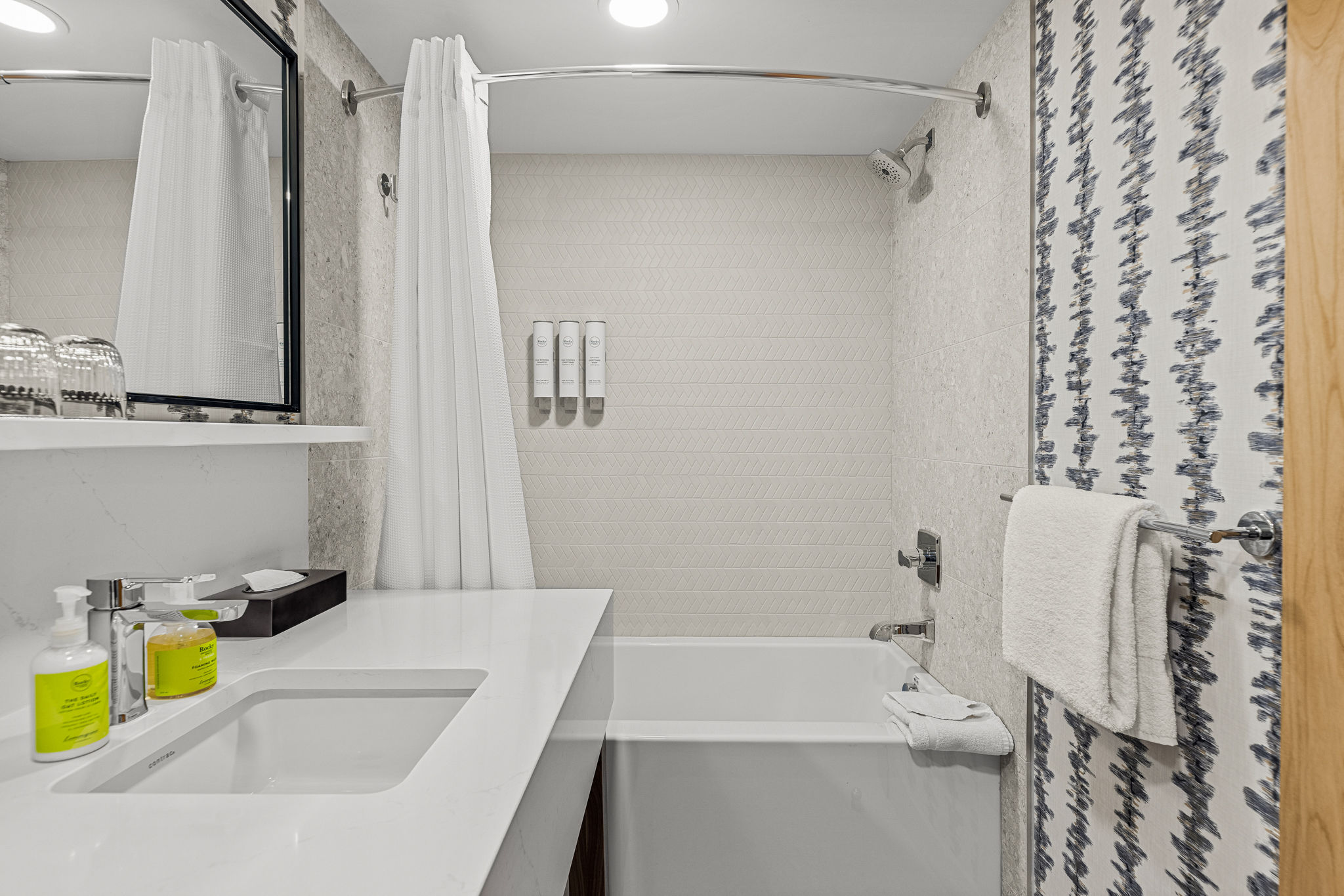 image Modern bathroom with a full tub and shower, offering a refreshing space to relax.
