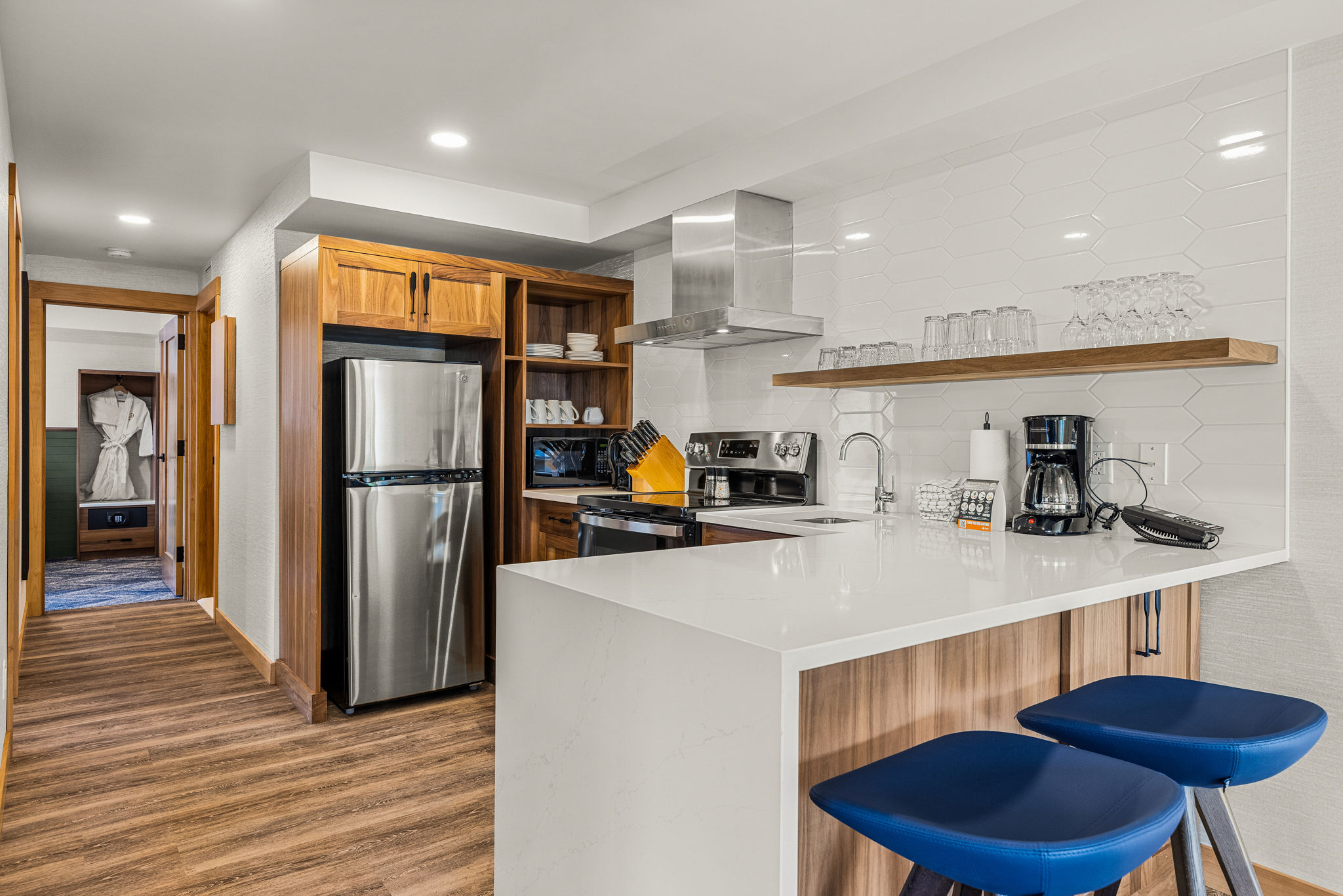 image Fully equipped kitchen with sleek appliances and a breakfast bar, perfect for cooking and dining in.