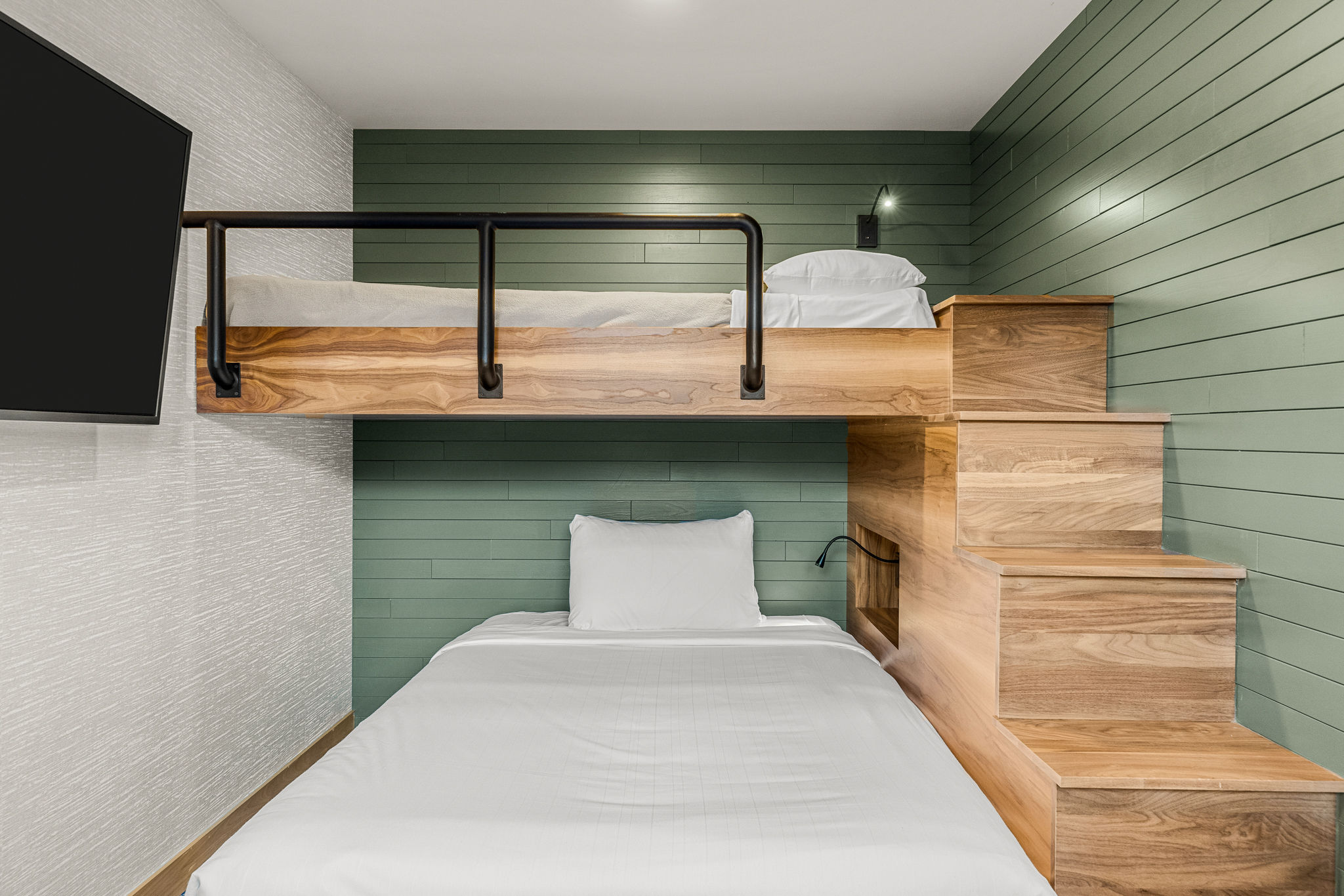 image Unique room layout featuring a cozy bed and stylish built-in bunk, perfect for families or groups.