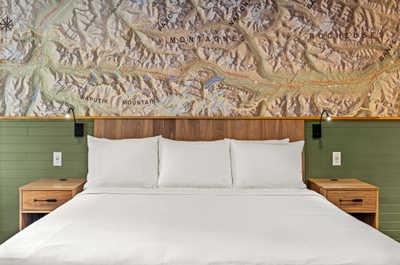 Comfortable bedroom featuring a plush bed and unique wall art for a restful night’s sleep.