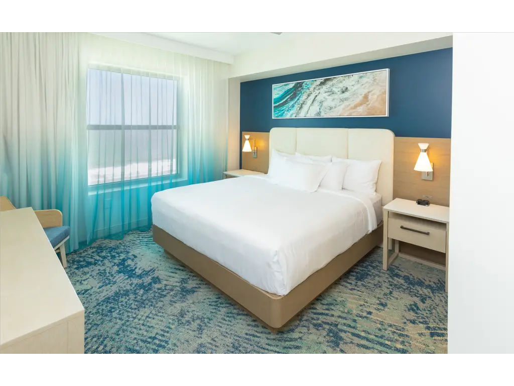 image Bright and airy bedroom with a plush bed, offering a relaxing and comfortable atmosphere.