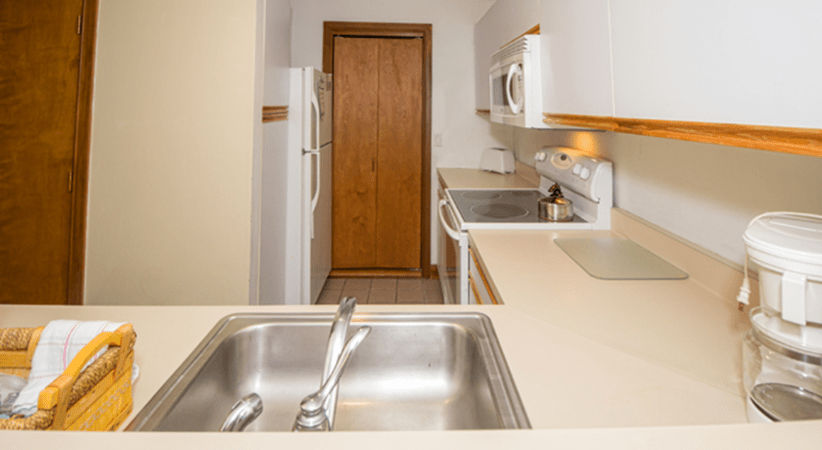 image The well-equipped kitchen boasts modern appliances, ample counter space for meal prep, and a clear view into the adjoining dining area.