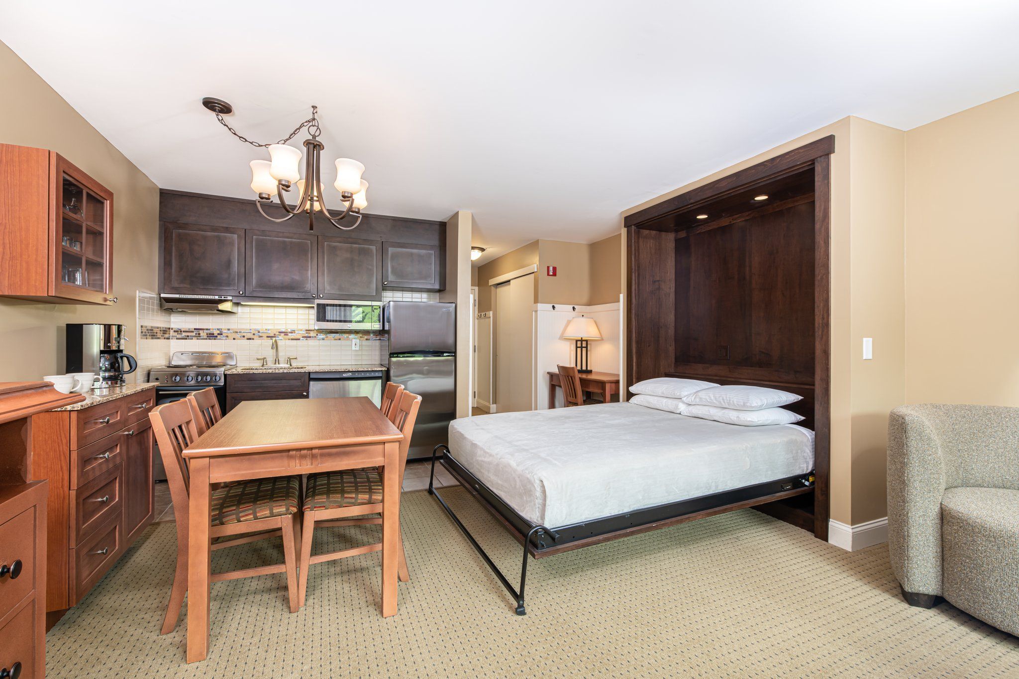 image Comfortable sleeping space adjacent to a welcoming kitchen, creating a homey and inviting atmosphere.