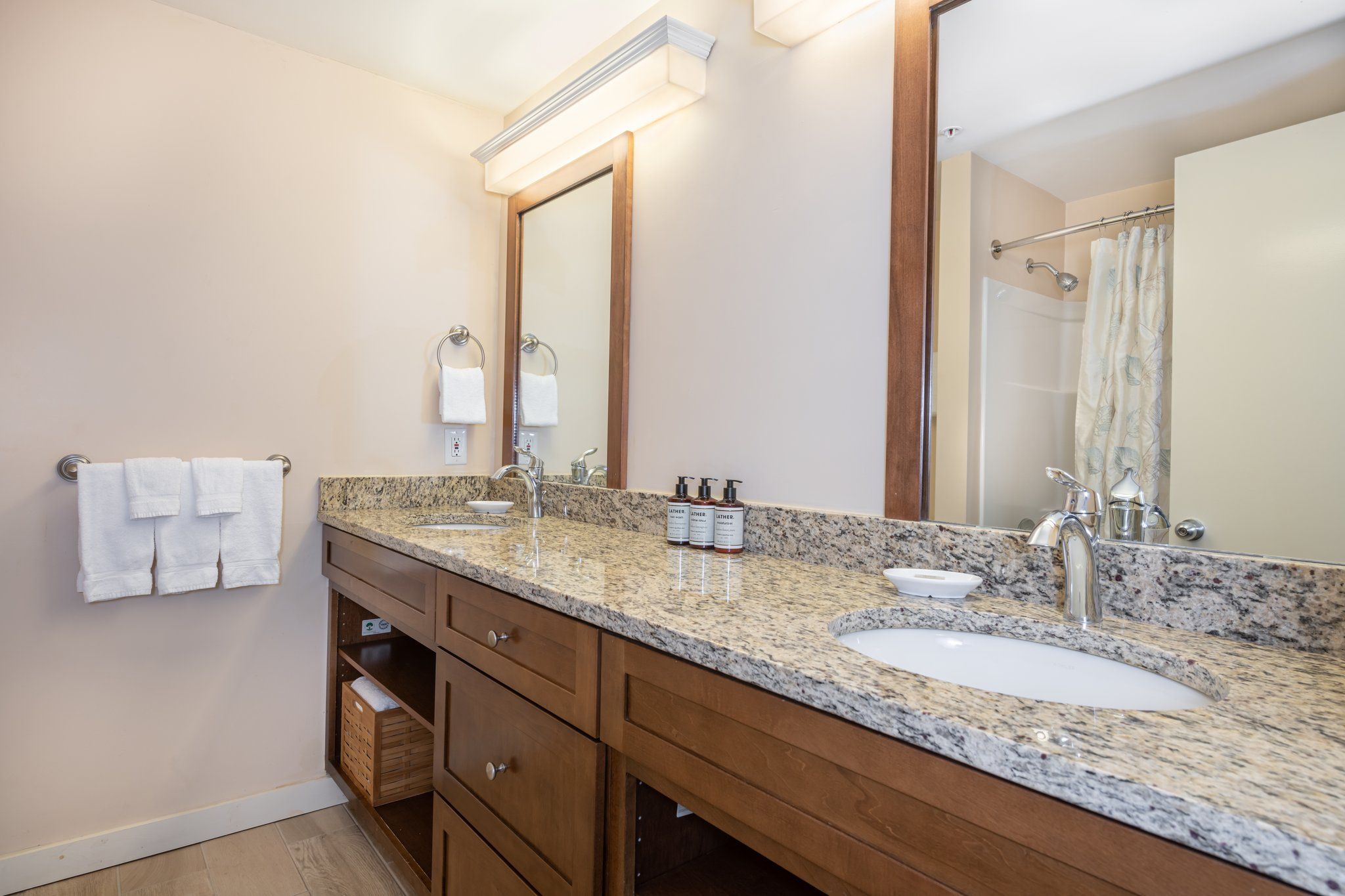image Bright bathroom featuring a large vanity, offering plenty of space for a relaxed and comfortable start to your day.