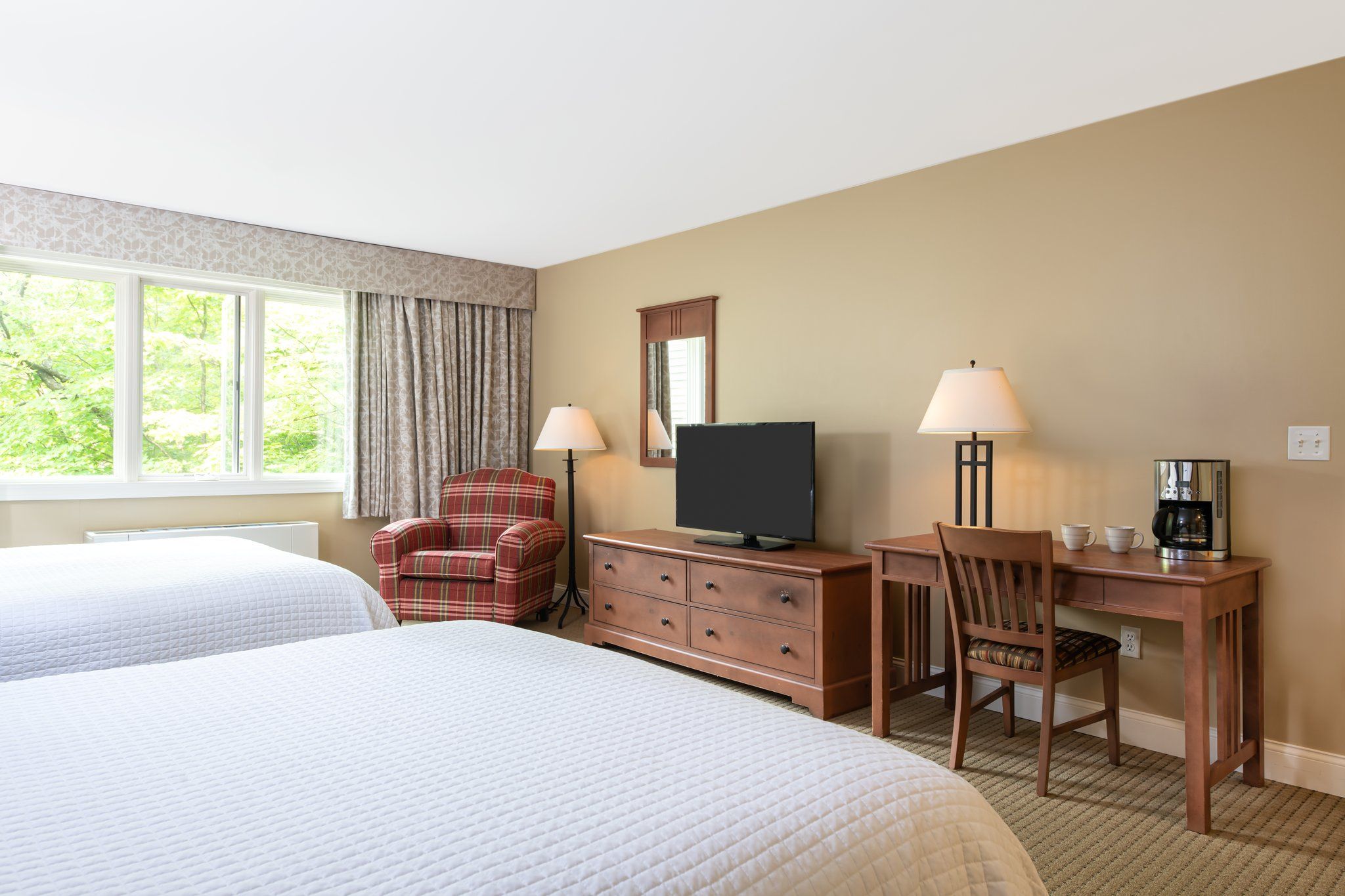 image Well-lit bedroom with a serene view, providing a calm and peaceful retreat.
