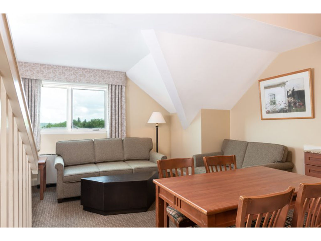 image Relax and connect in the inviting living and dining area, designed to make you feel at home with its cozy furnishings and welcoming atmosphere.