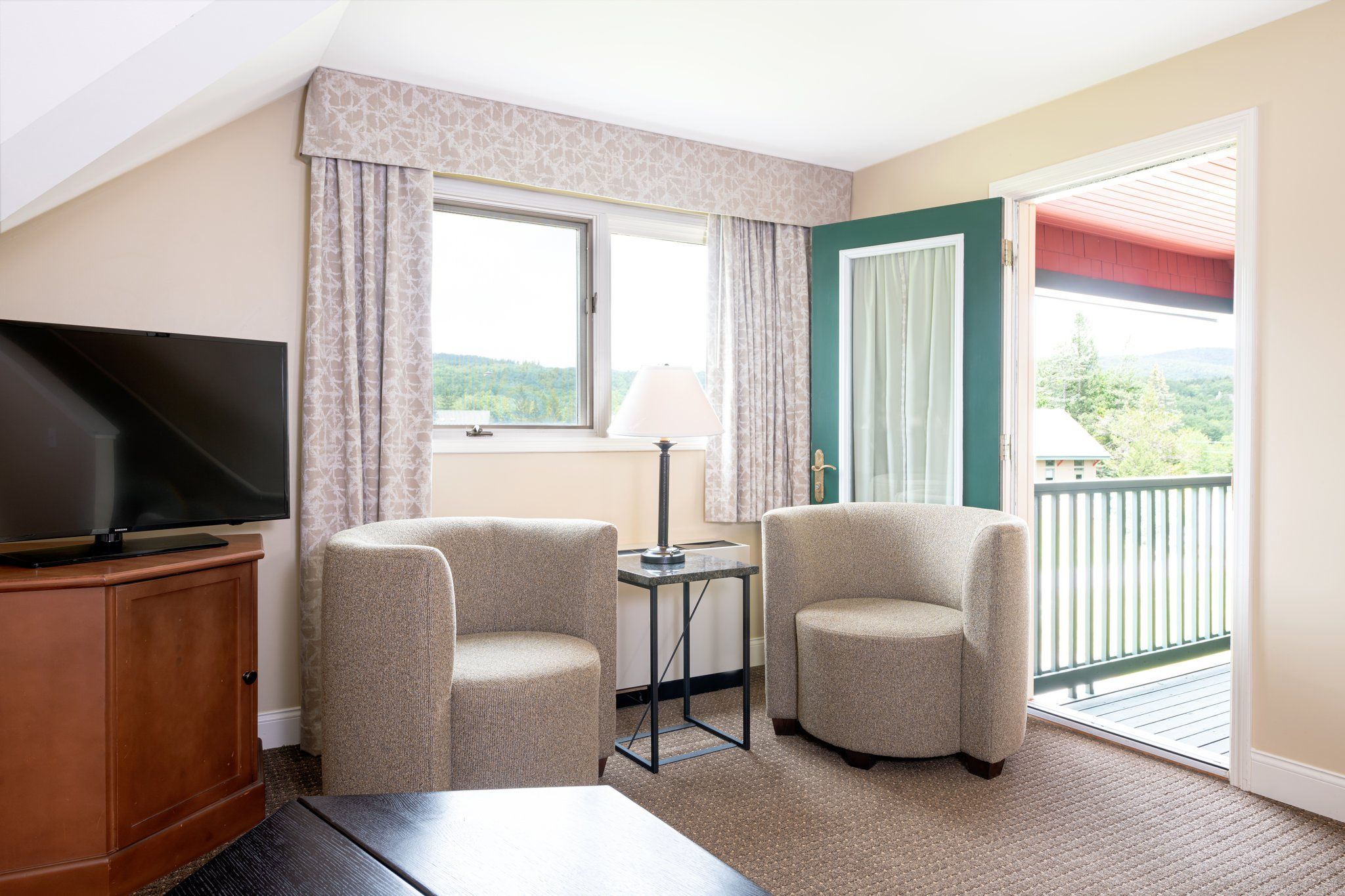 image Bright and airy, this living area opens up to a balcony, offering a seamless blend of indoor comfort and outdoor enjoyment.