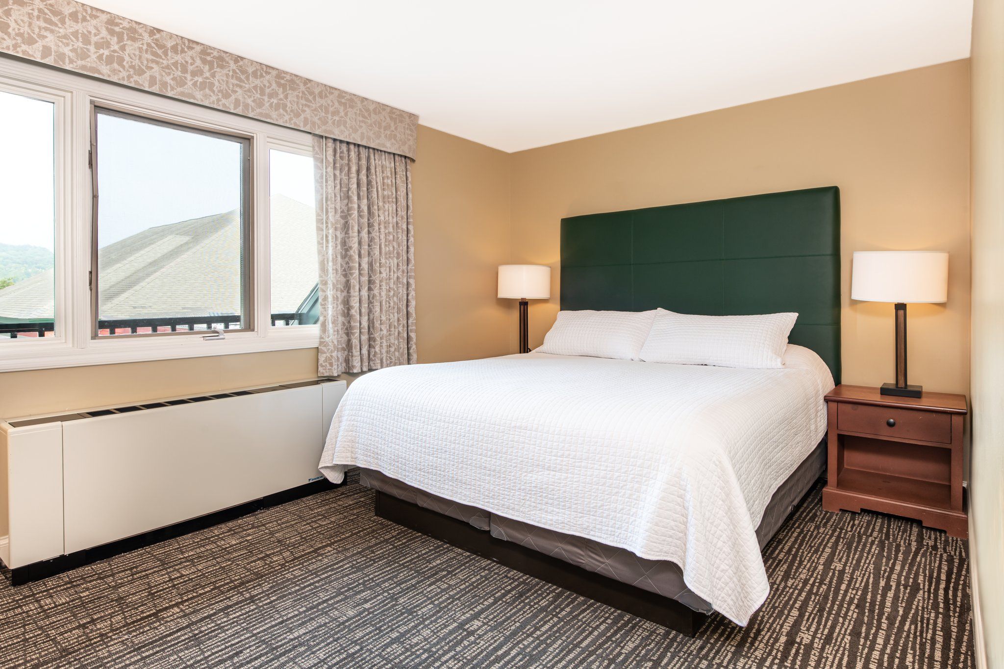 image Relax in this cozy bedroom featuring a comfortable bed and soft lighting, perfect for unwinding after a day of exploring.
