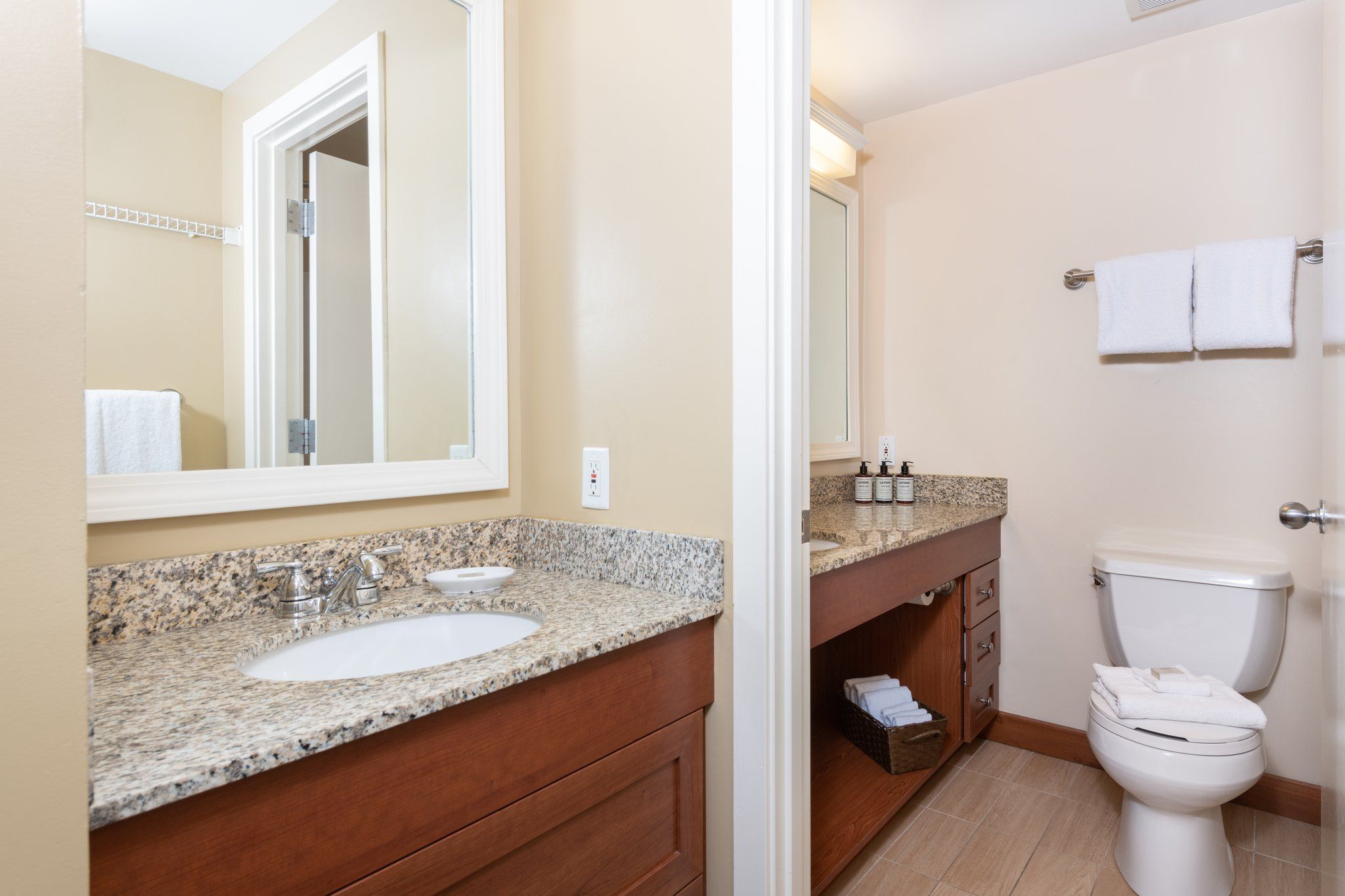 image Well-appointed bathroom with a large countertop and bright lighting, providing a comfortable and refreshing space for your stay.