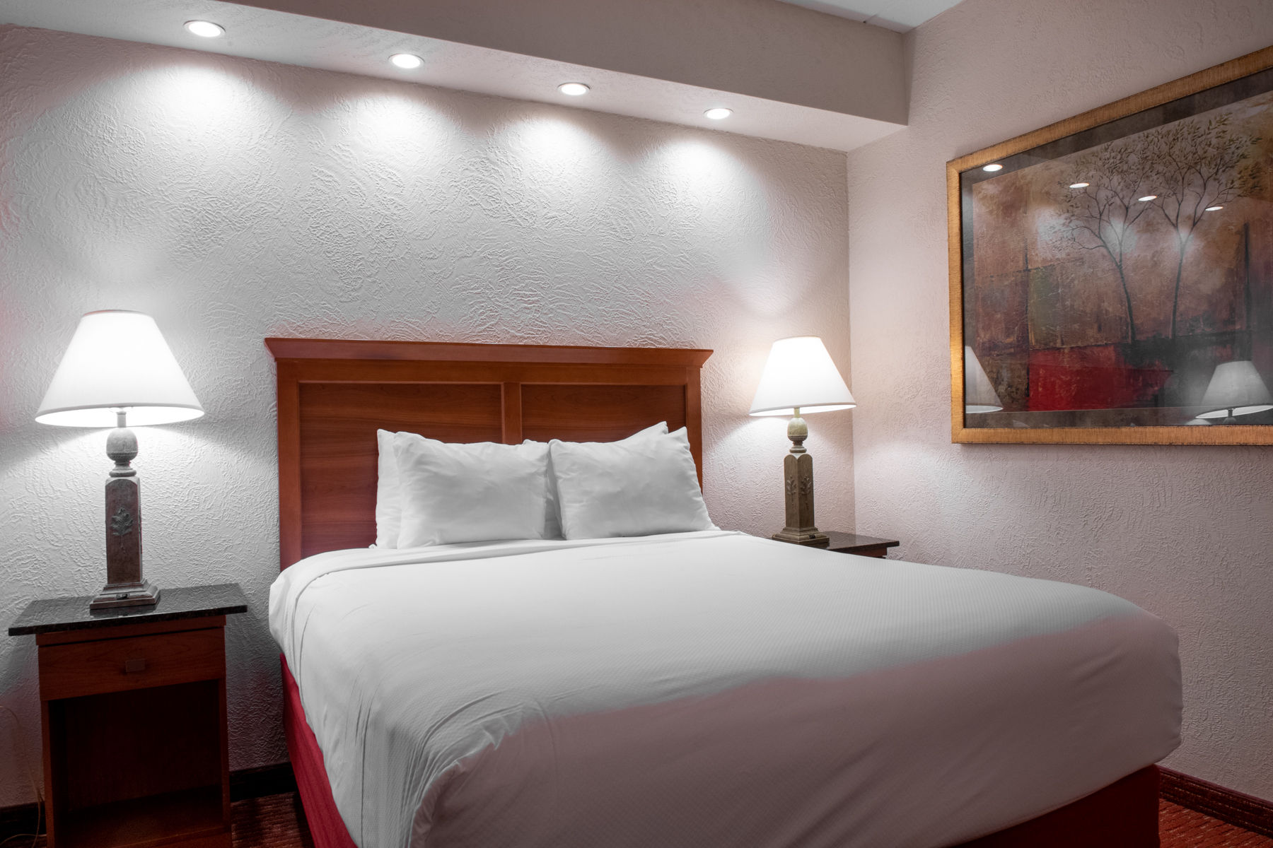 image Cozy bedroom with soft lighting, elegant decor, and a plush bed for a restful night's sleep.