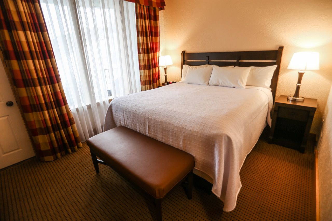image Cozy bedroom with a plush bed, soft lighting, and elegant curtains creating a warm, inviting ambiance.