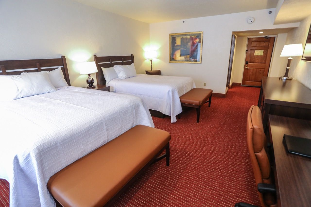 image Spacious room with plush beds, cozy seating, and warm lighting, creating a comfortable and inviting atmosphere.